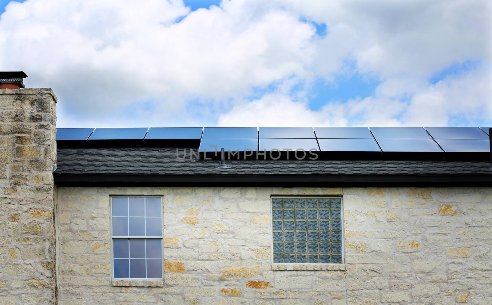 Old limestone house with a solar panels on a roof