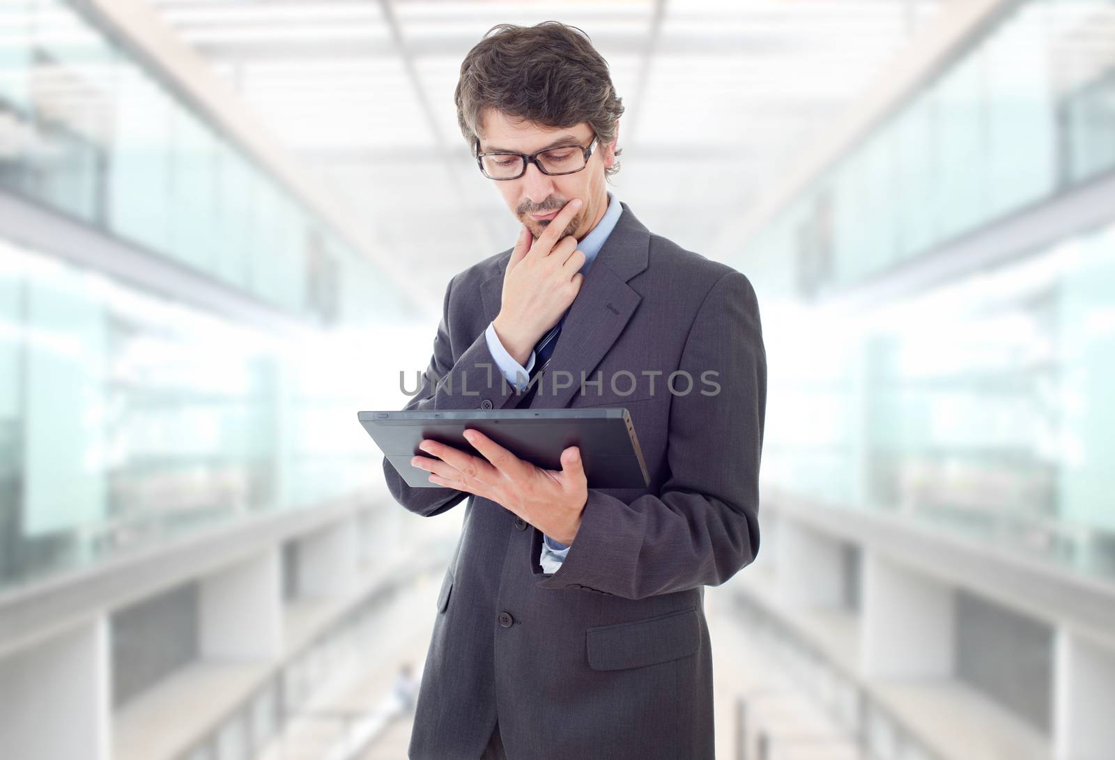 businessman thinking with a tablet pc, at the office