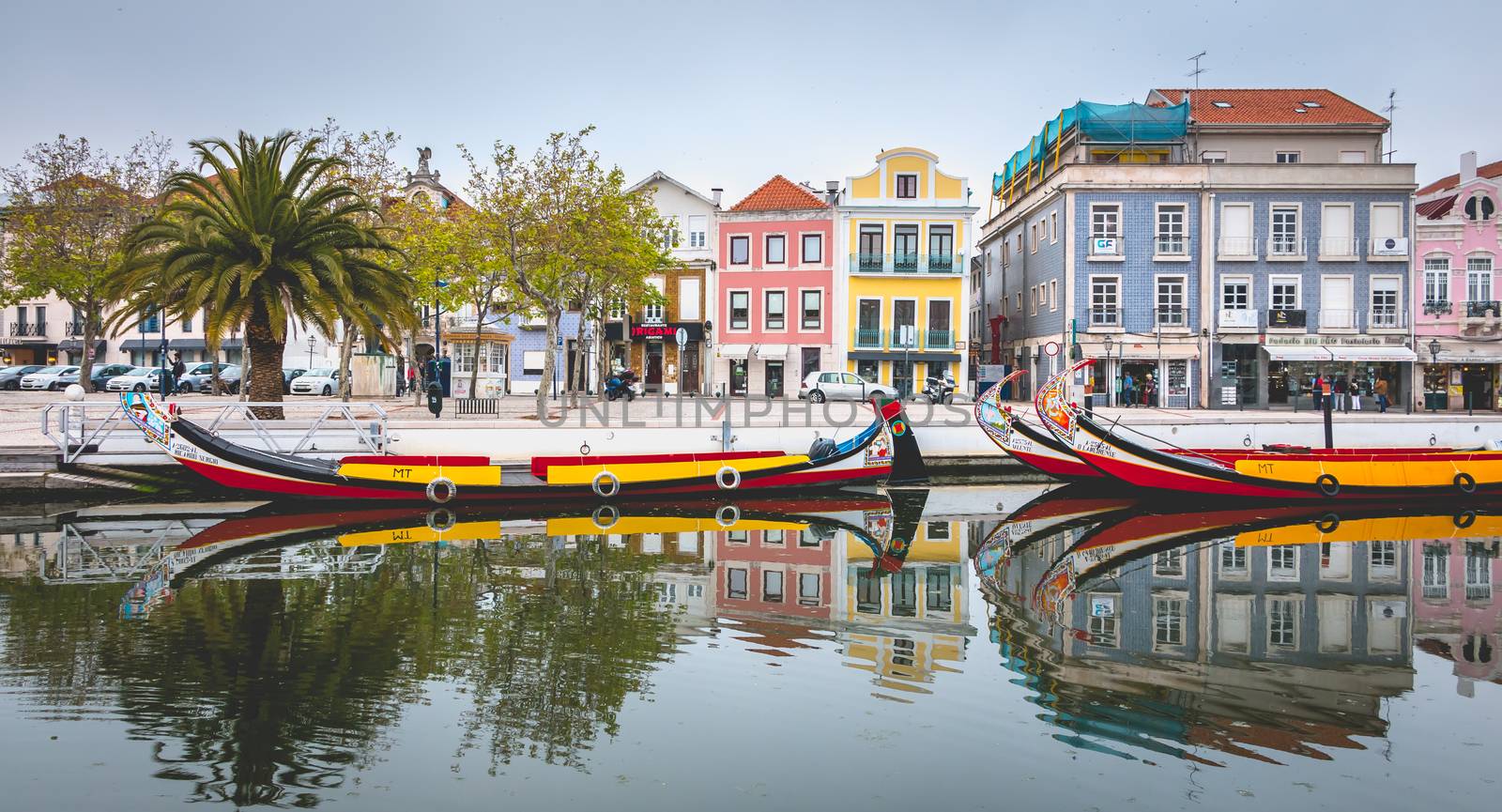 Aveiro, Portugal - May 7, 2018: Tourists walk on famous Moliceiros on a spring evening, traditional boats used to harvest seaweeds in the past