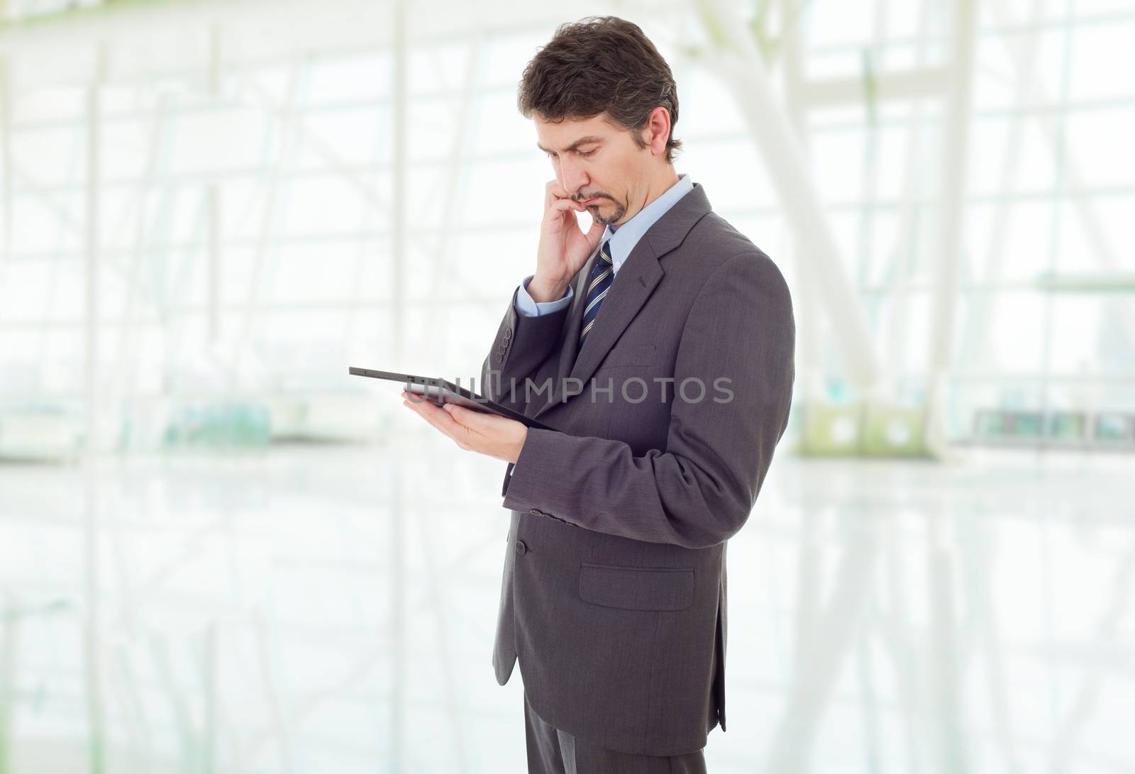 young businessman working with a tablet pc, at the office