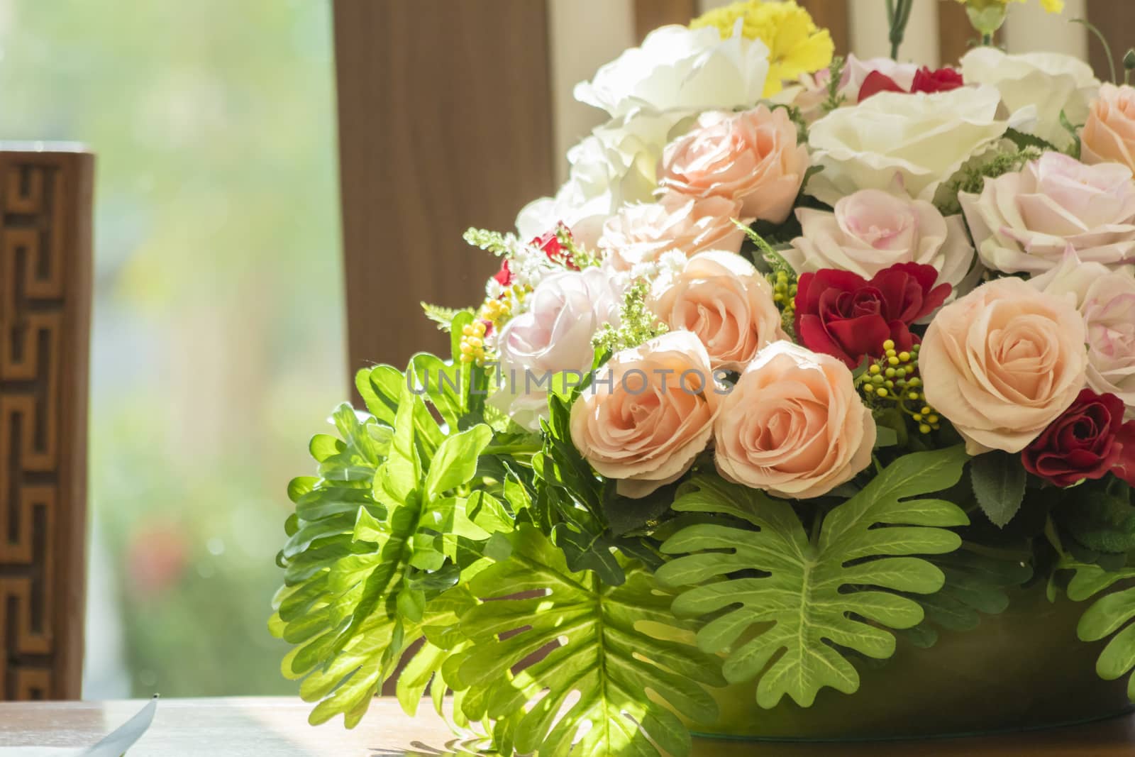 Colorful roses with green leaf on table,decoration flower