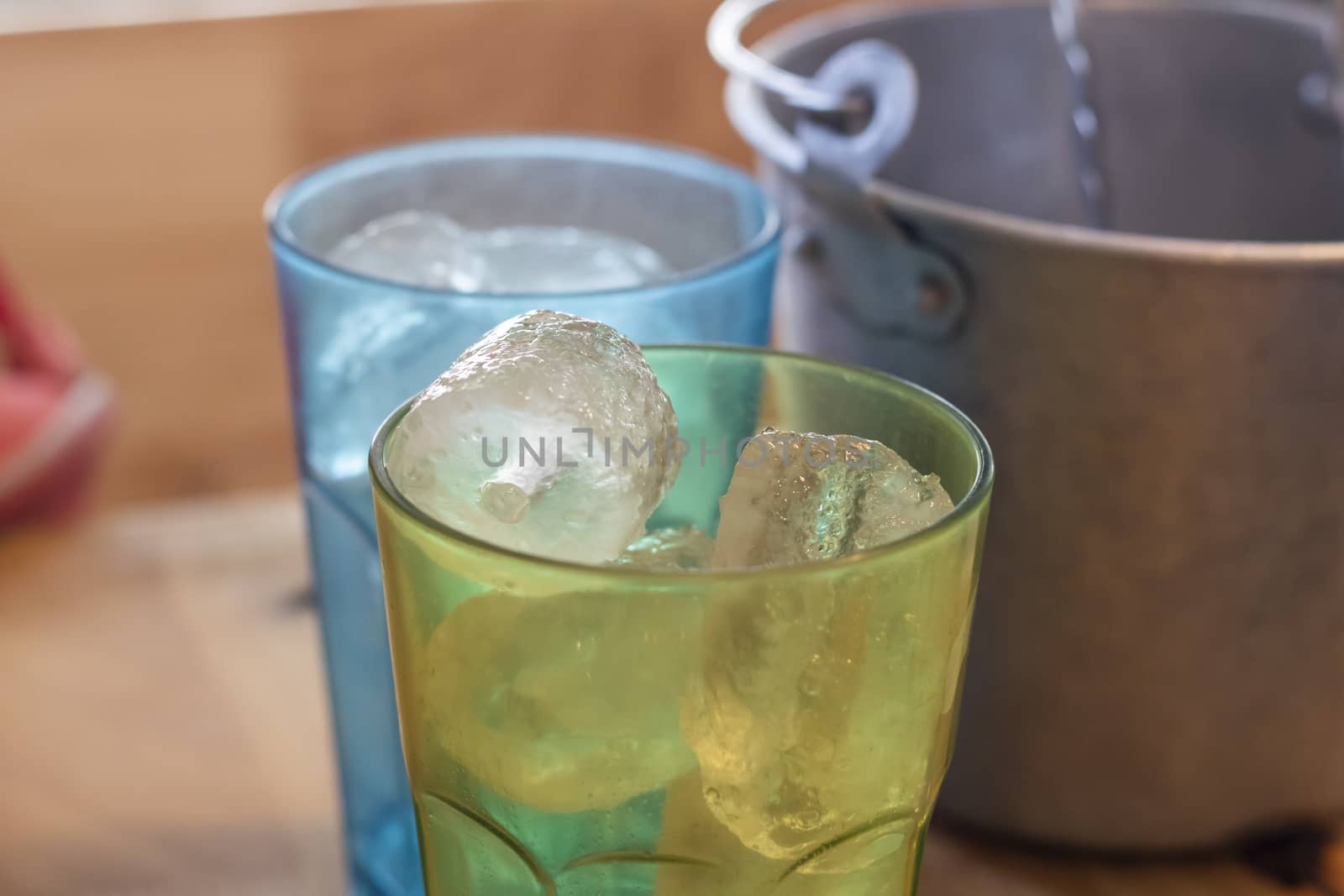 Ice cube in the glass on table