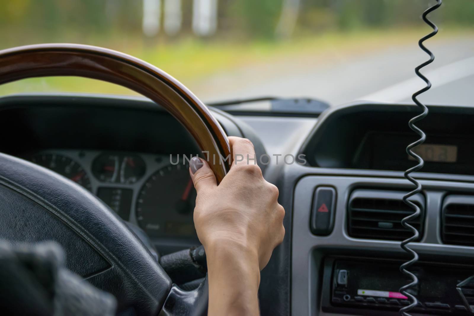 view of the hand of the people, the driver, holding the wheel of the car, close-up