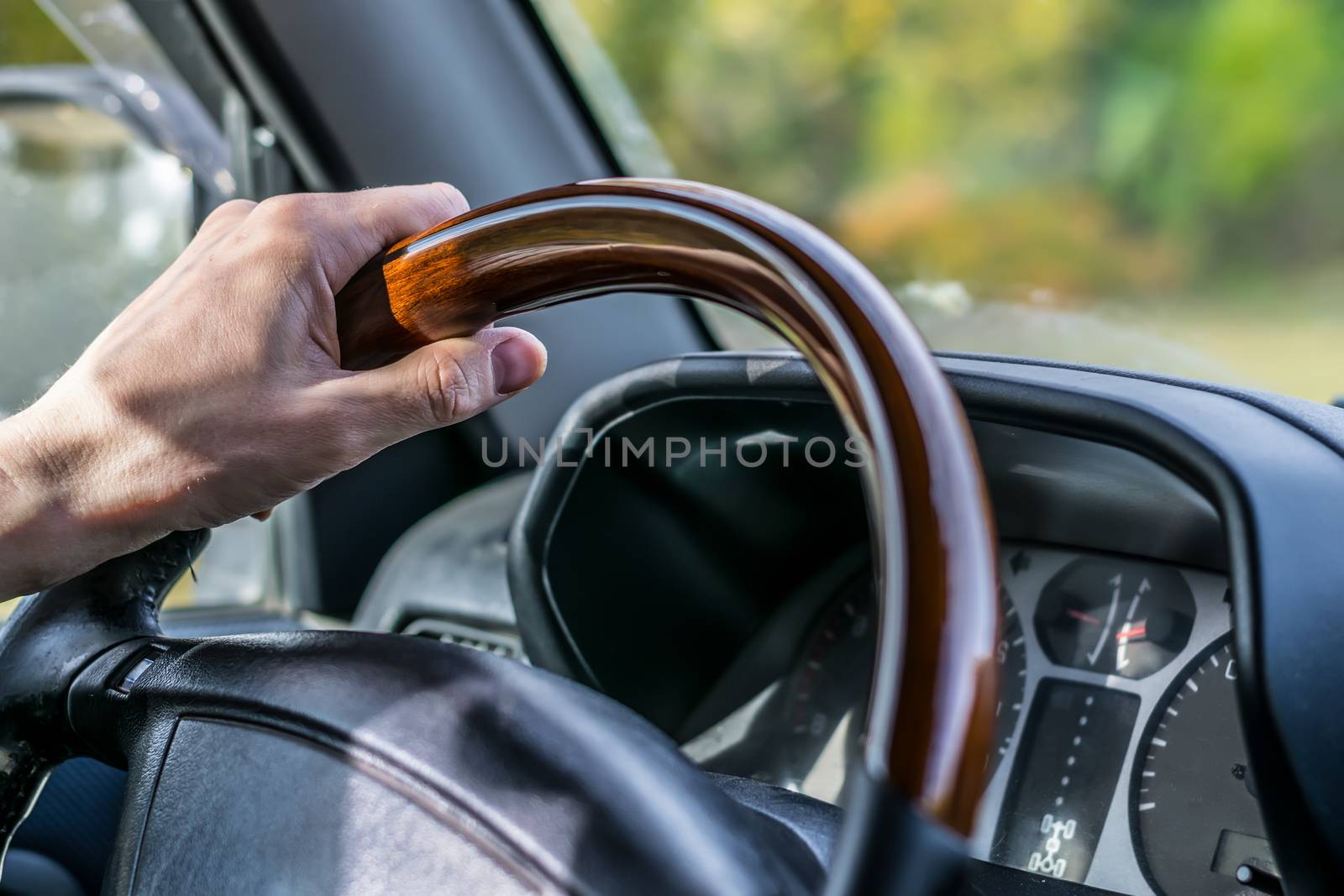 view of the hand of the people, the driver, holding the wheel of the car, close-up by jk3030