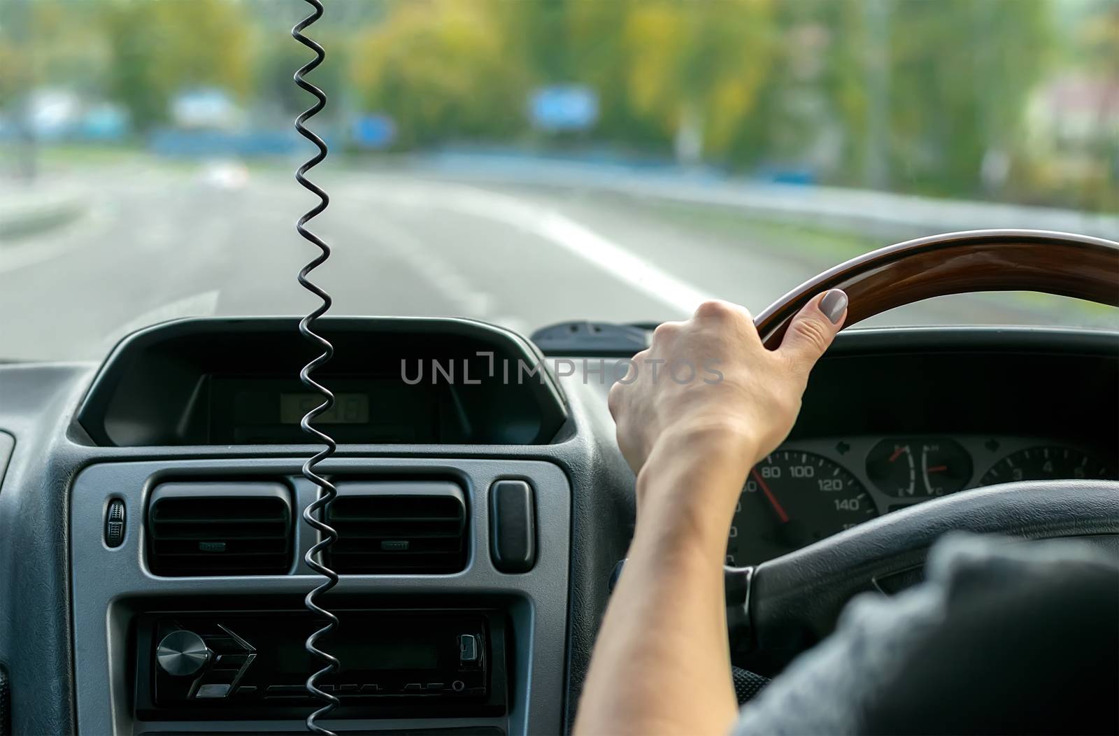 view of the hand of the people, the driver, holding the wheel of the car, close-up