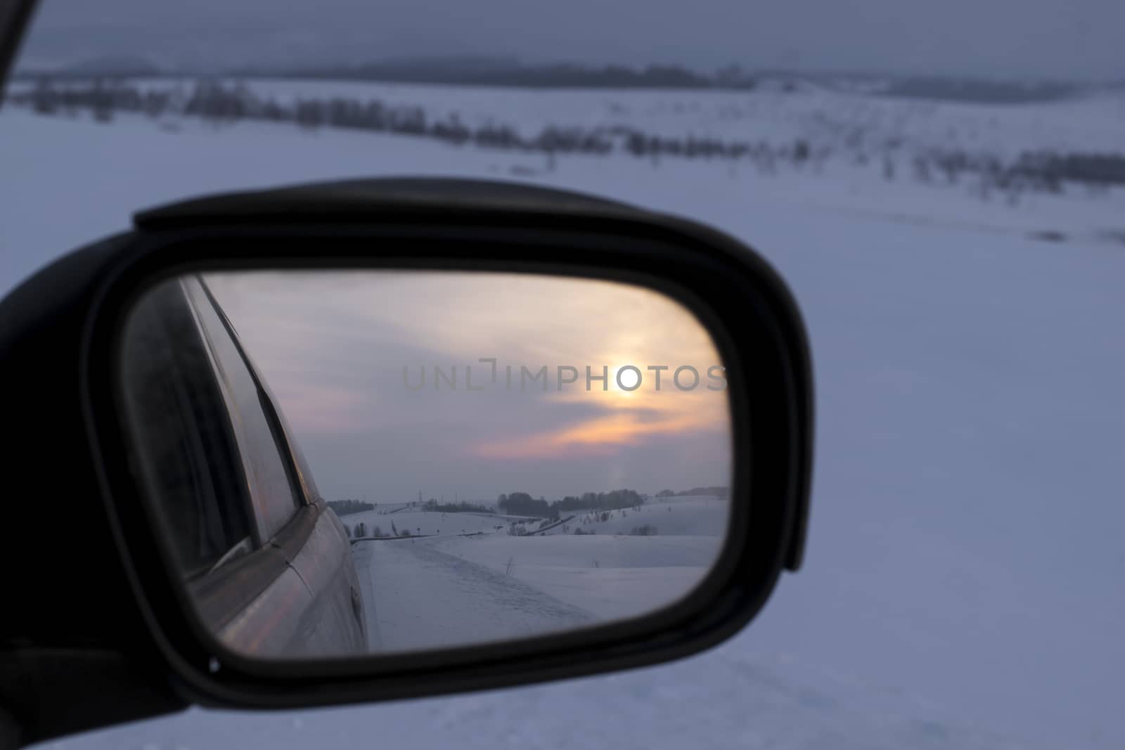 reflection in rear view mirror of night road, hills and sunset by jk3030