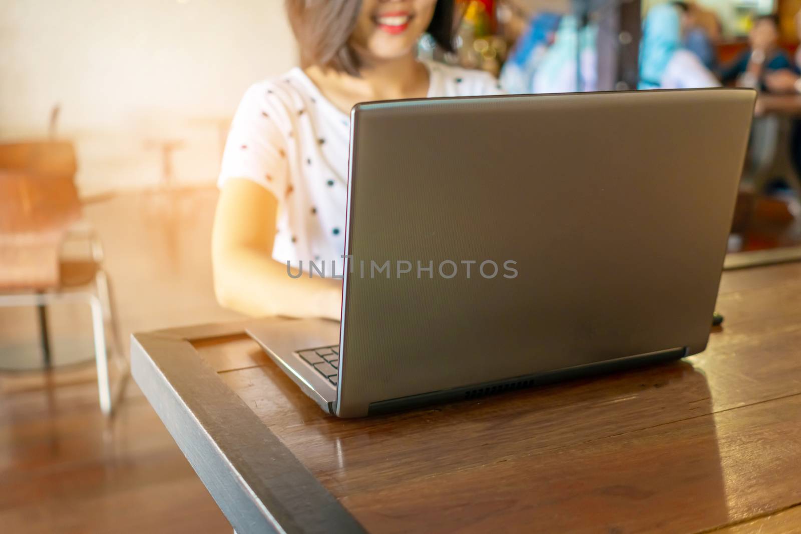 Happy woman smile while using laptop to work study on work desk with clean nature background background. Business, financial, trade stock maket and social network. by Suwant