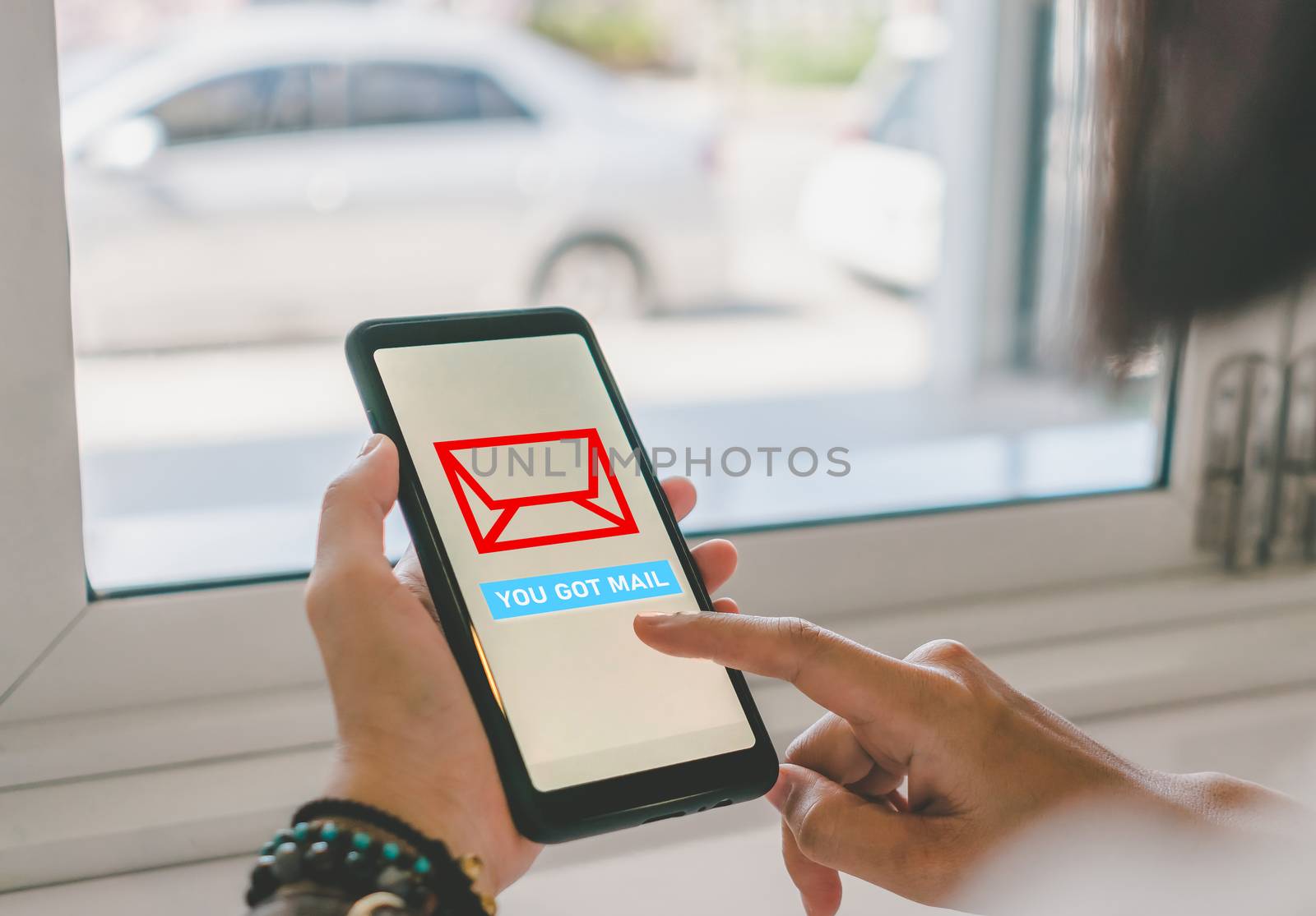 Woman hand use smartphone in public area with 1 new email alert sign icon pop up. Communication business technology concept.