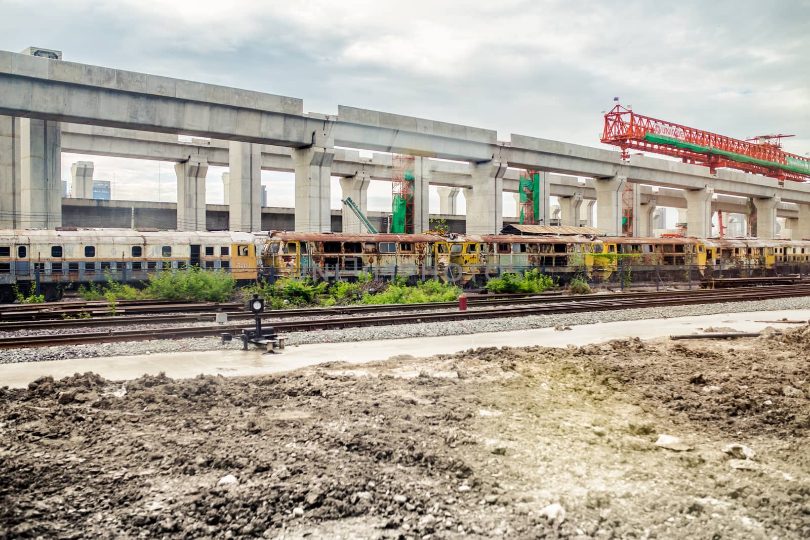 The old locomotive and The sky train being built.