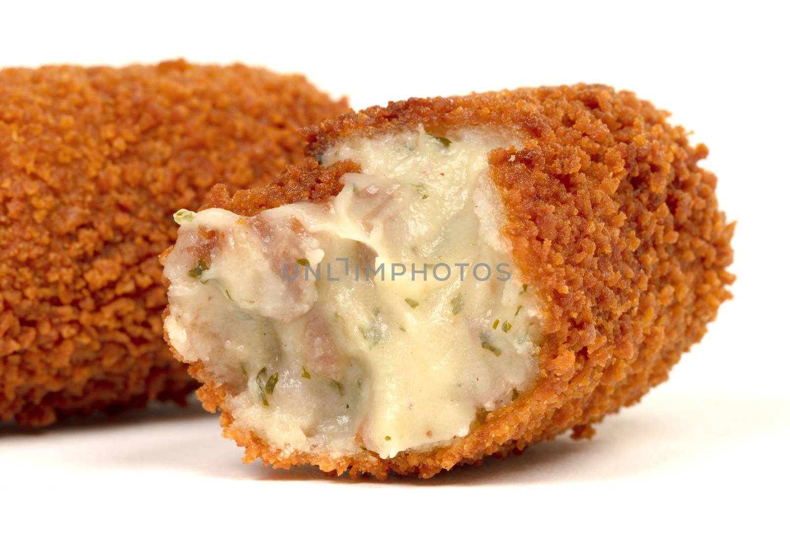 Partly eaten brown crusty dutch kroket isolated by michaklootwijk