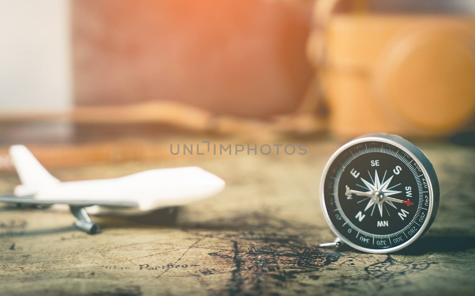Plane compass and camera on vintage map by junce