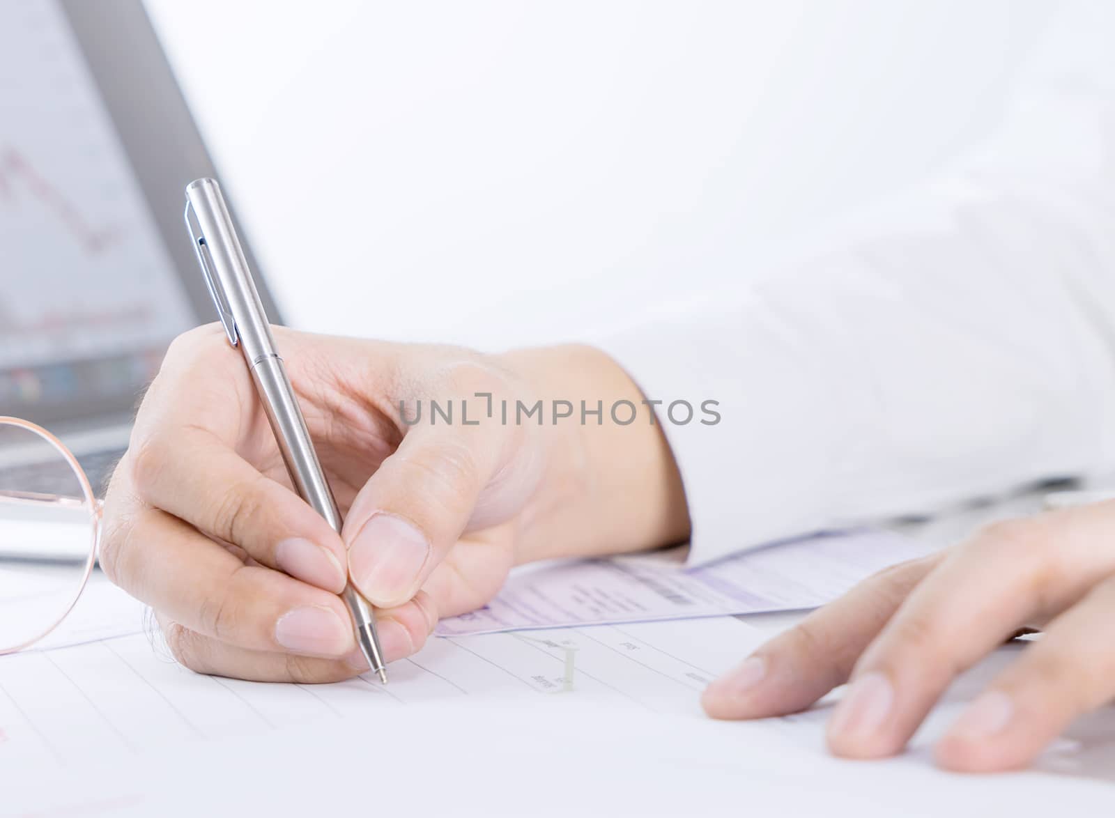 Business man is signing a financial document on office table by junce