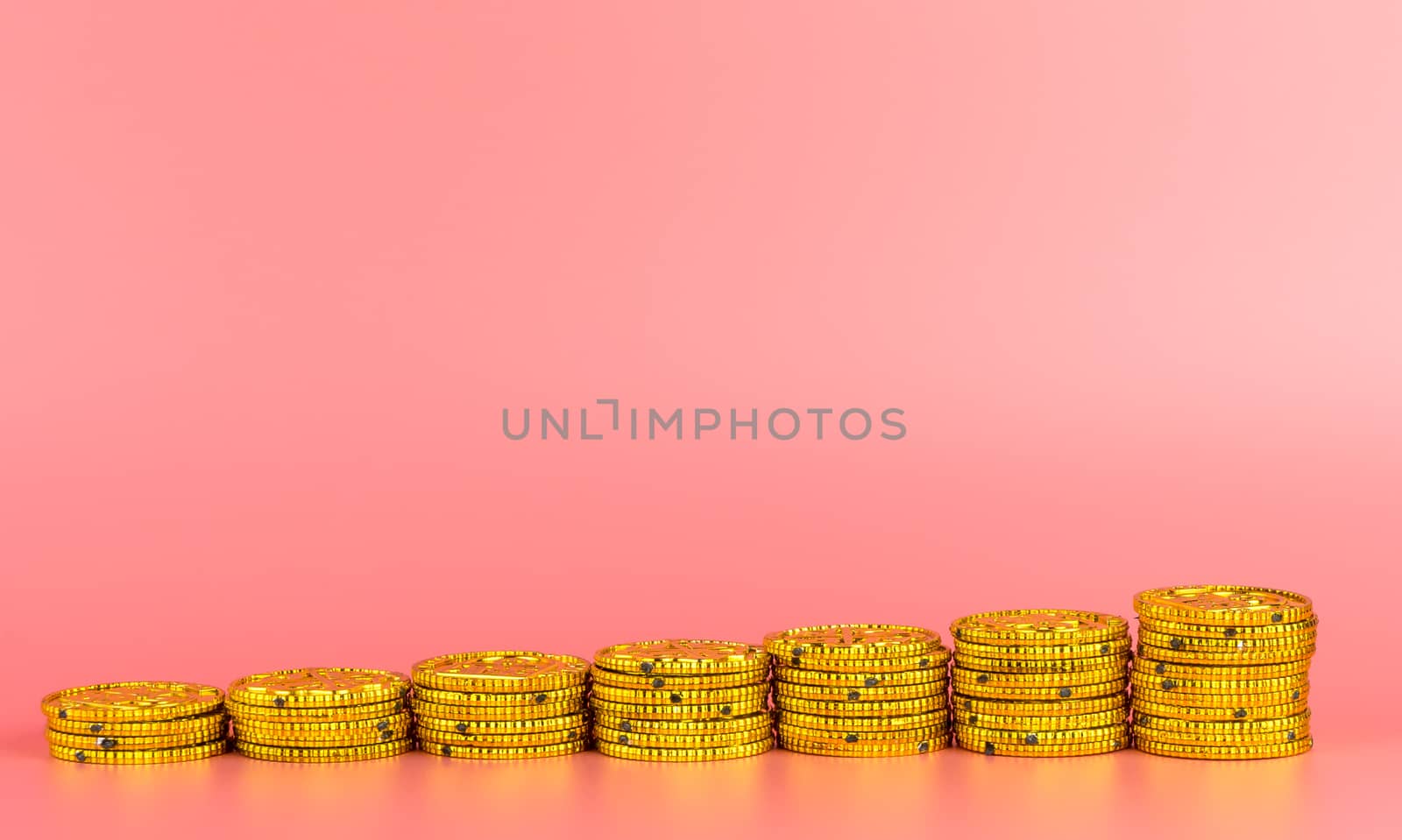 Gold coin money growing concept on pink background by junce