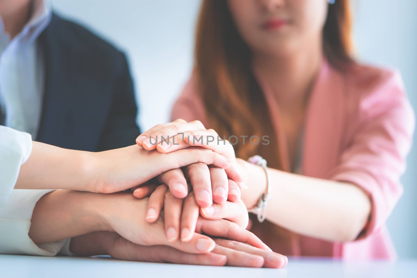 Office people putting hand together for business team success concept