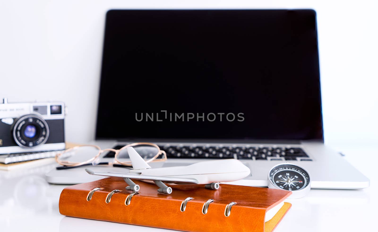 Blank laptop screen with travel accessories for Online travel agency mock up by junce