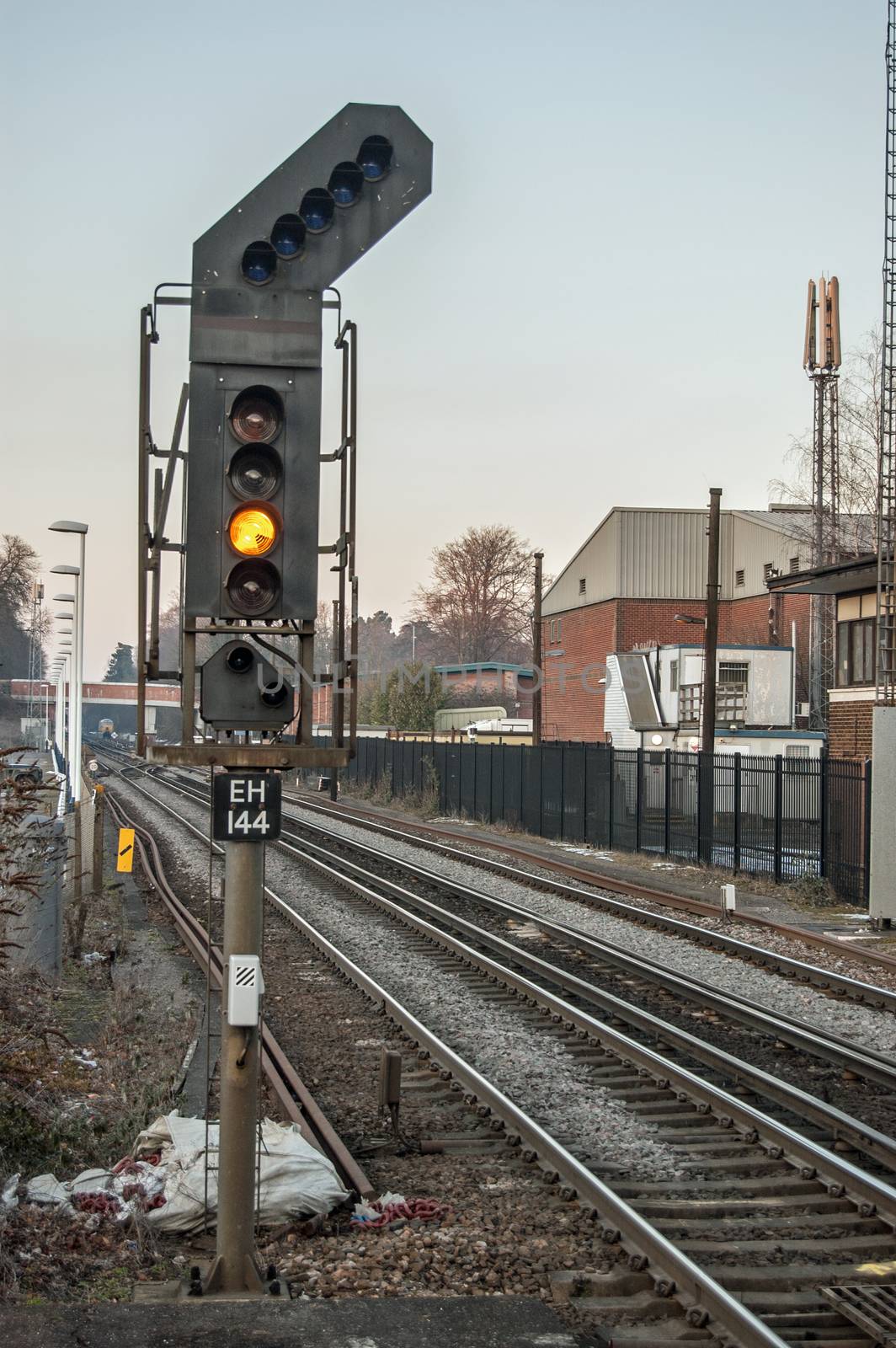 Yellow caution signal on railway line in UK by BasPhoto