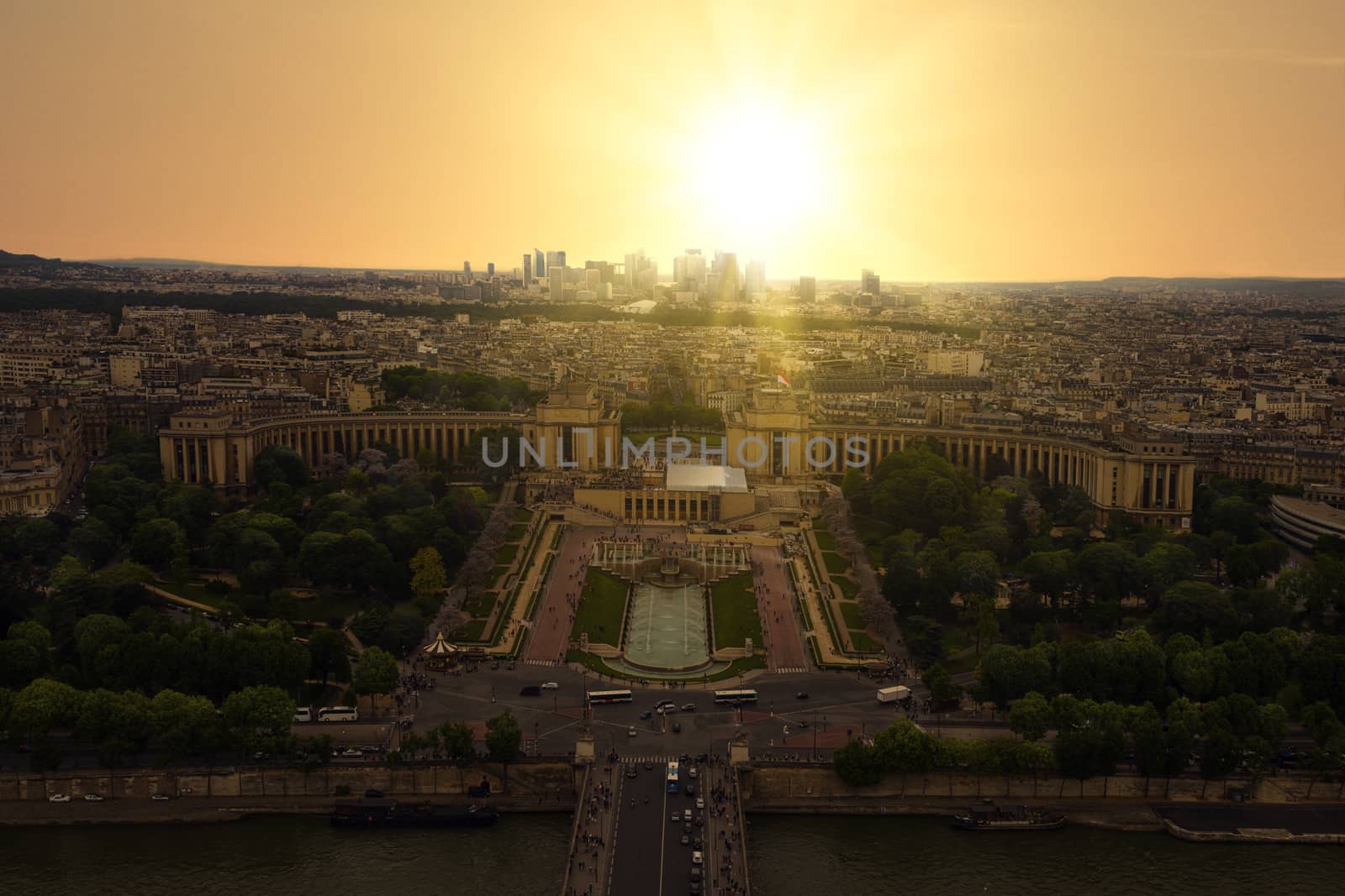 Sunset view from the Eiffel tower on Paris city, Champs de Mars, Trocadéro and skyline toward La Défense business district, France