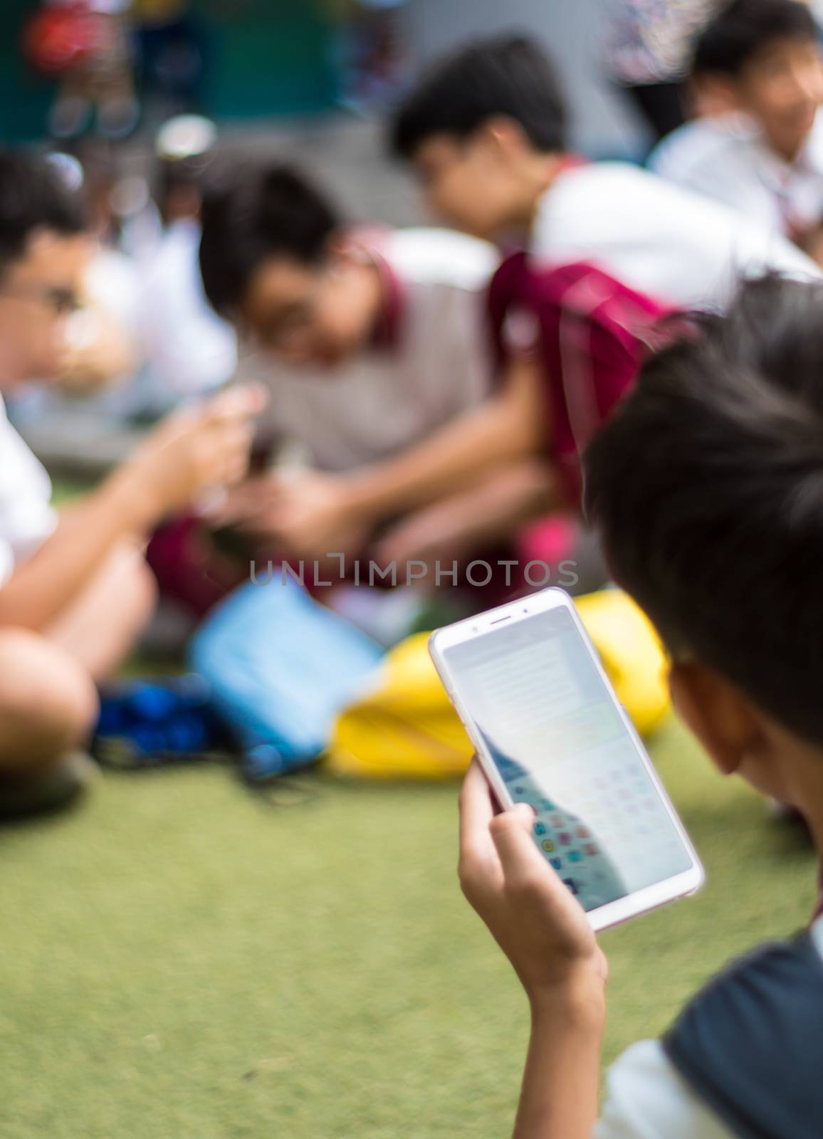 BANGKOK THAILAND - April 19,2018 Many Serious children playing on smartphone, Children playing on smartphone during the brake time in school