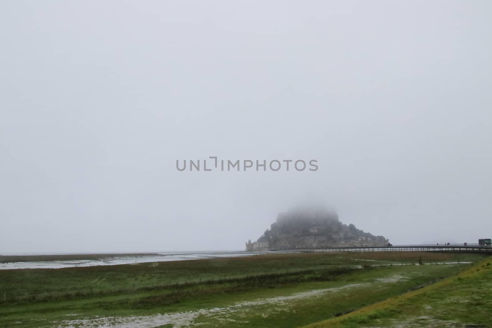 Panoramic views of Mont Saint Michel in a foggy morning. Stratified fog and suggestive view of the place