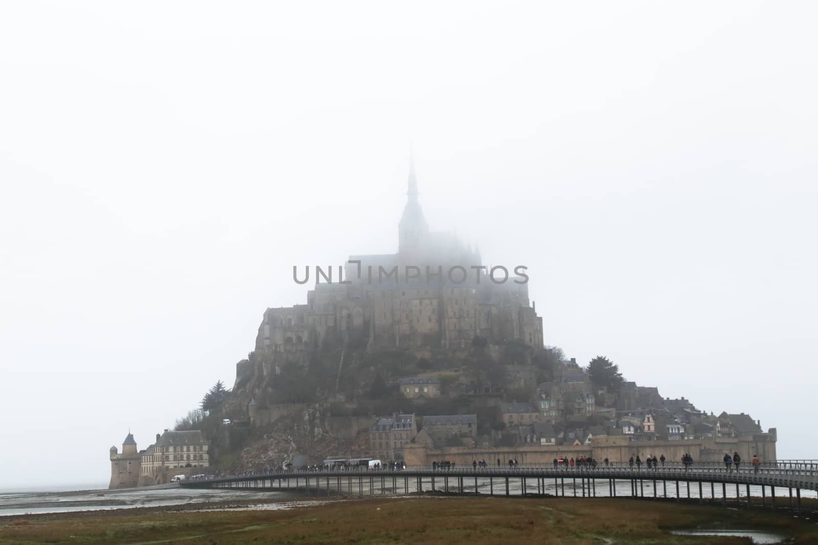 Panoramic views of Mont Saint Michel in a foggy morning. Stratified fog and suggestive view of the place