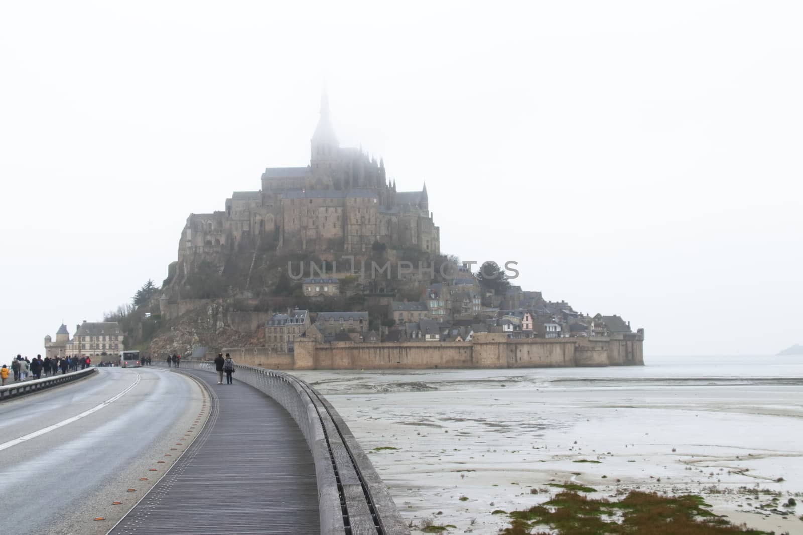 Panoramic views of Mont Saint Michel in a foggy morning. Stratified fog and suggestive view of the place