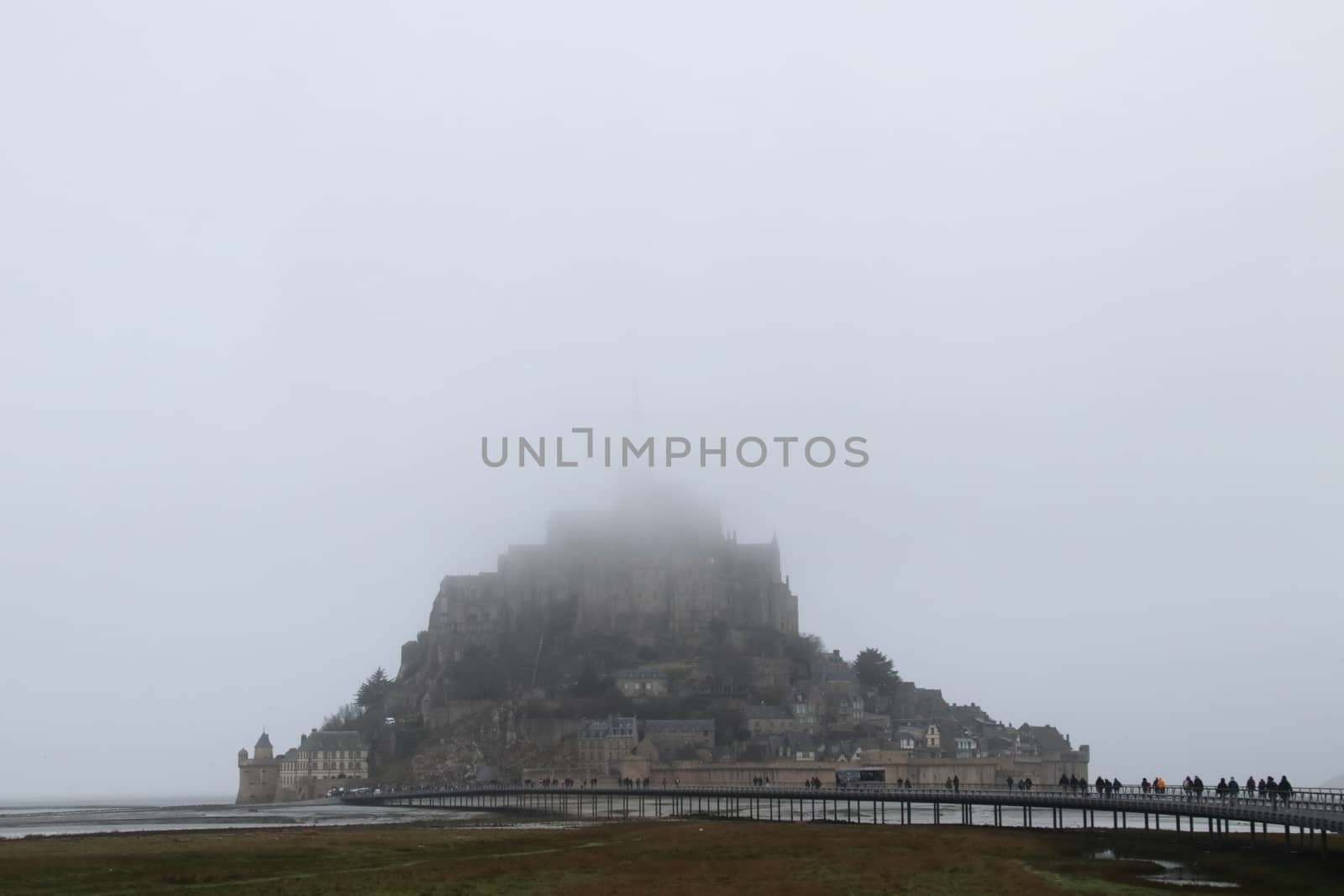 Panoramic views of Mont Saint Michel in a foggy morning. Stratified fog and suggestive view of the place