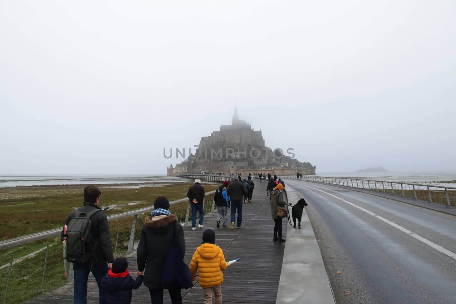 Panoramic views of Mont Saint Michel in a foggy morning. Stratified fog and suggestive view of the place