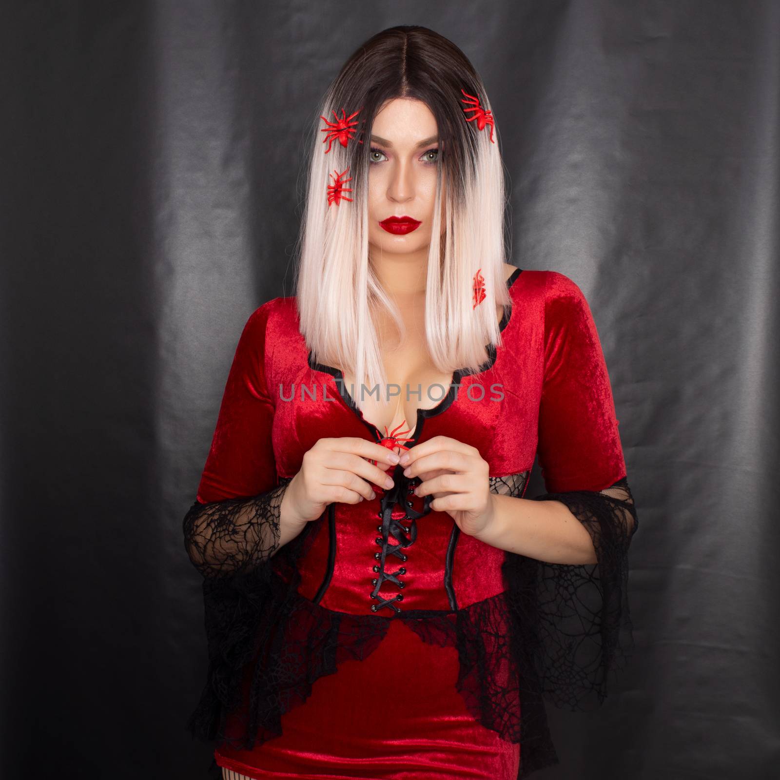 Blonde woman in vampire costume with many red spiders on her hair by Bonda