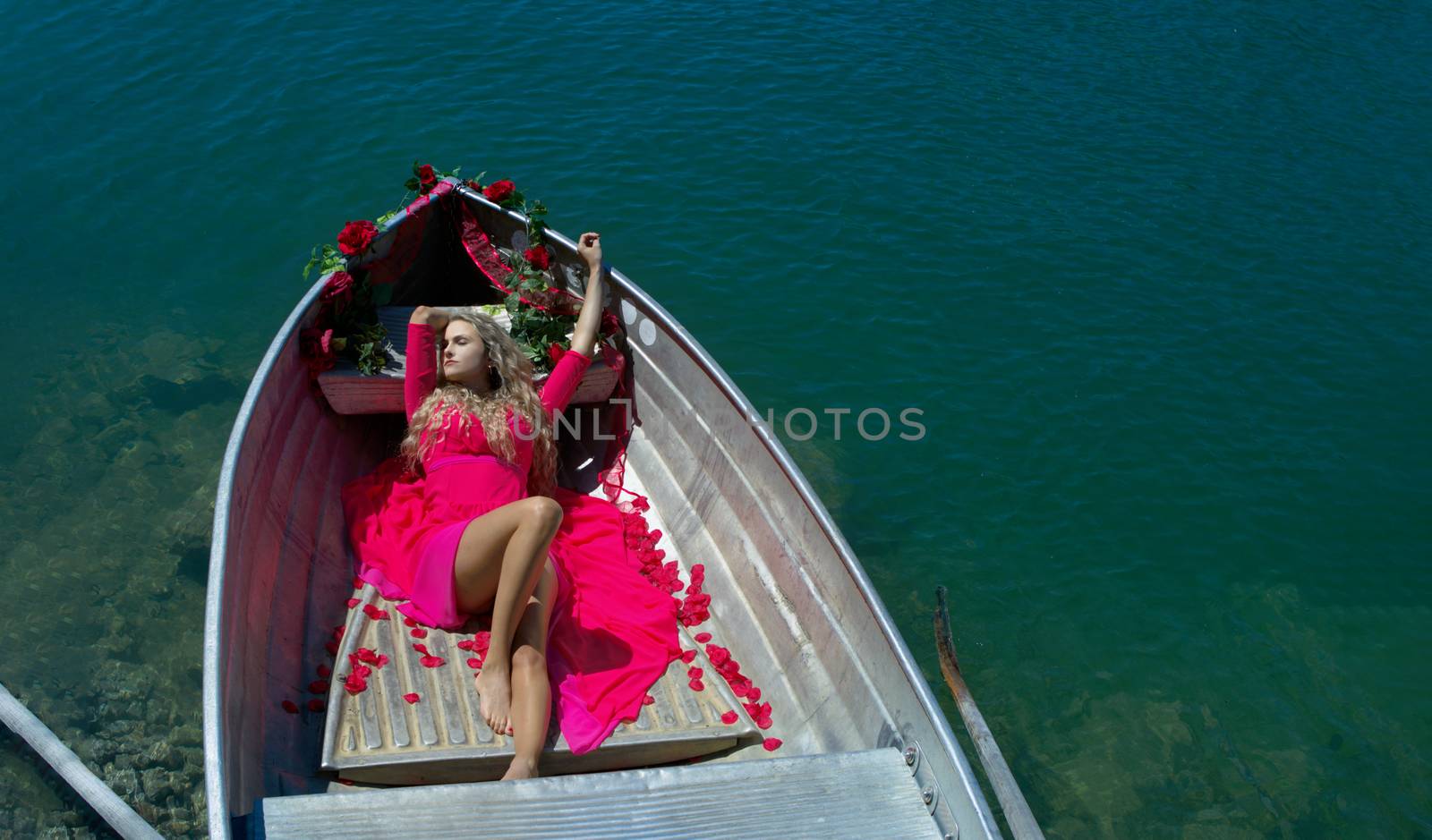 Life style woman with red dress and roses on a lake by PeterHofstetter