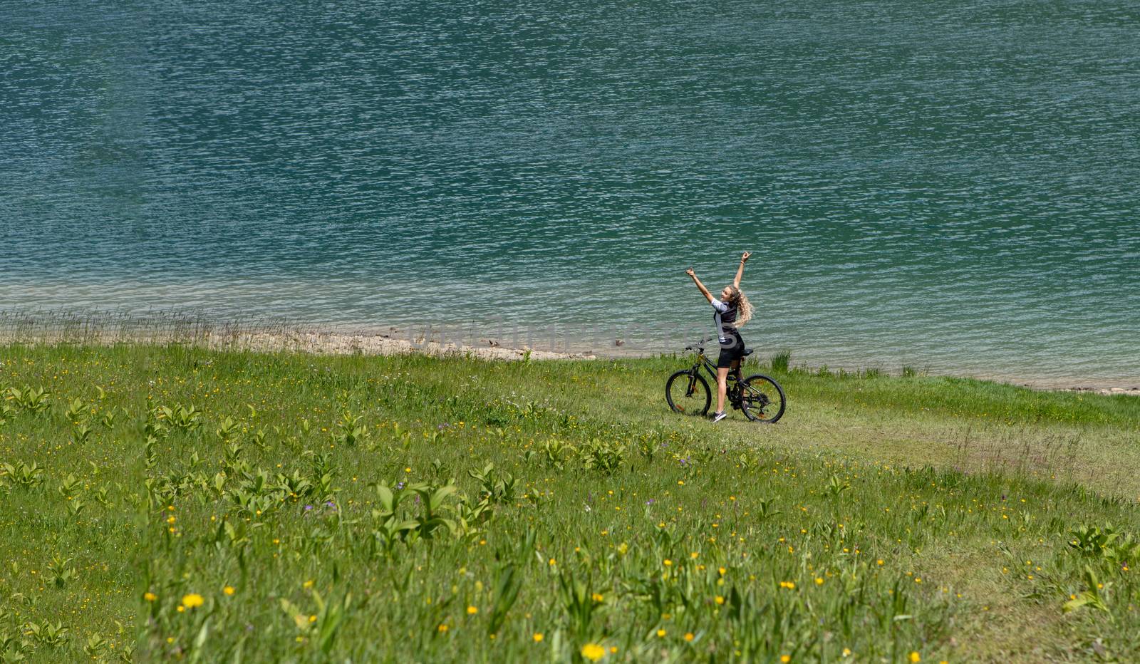 Life style woman with long blond hair on mountain bike in Swiss by PeterHofstetter