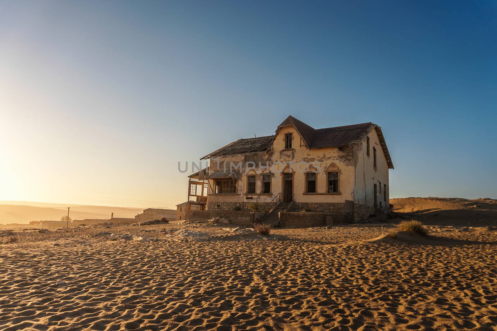 Sunrise above an abandoned house in Kolmanskop ghost town located in southern Namibia near the town of Luderitz.