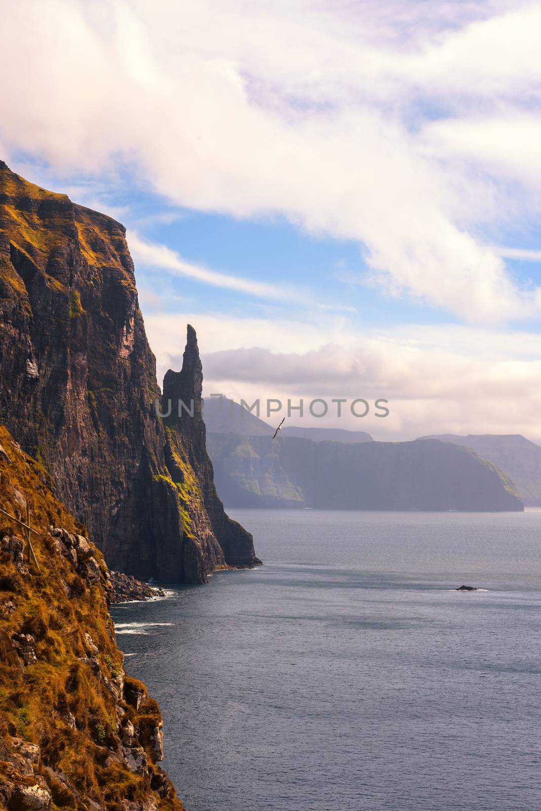 Trollkonufingur rock, also called The Witch's Finger on the island of Vagar. Trollkonufingur is a freestanding sea stack rock on the east of Sandavagur village on the Faroe Islands.