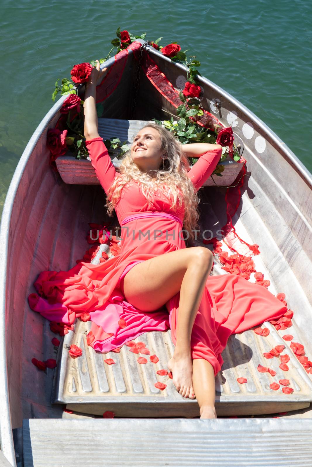 Life style woman with red dress and roses on a lake by PeterHofstetter