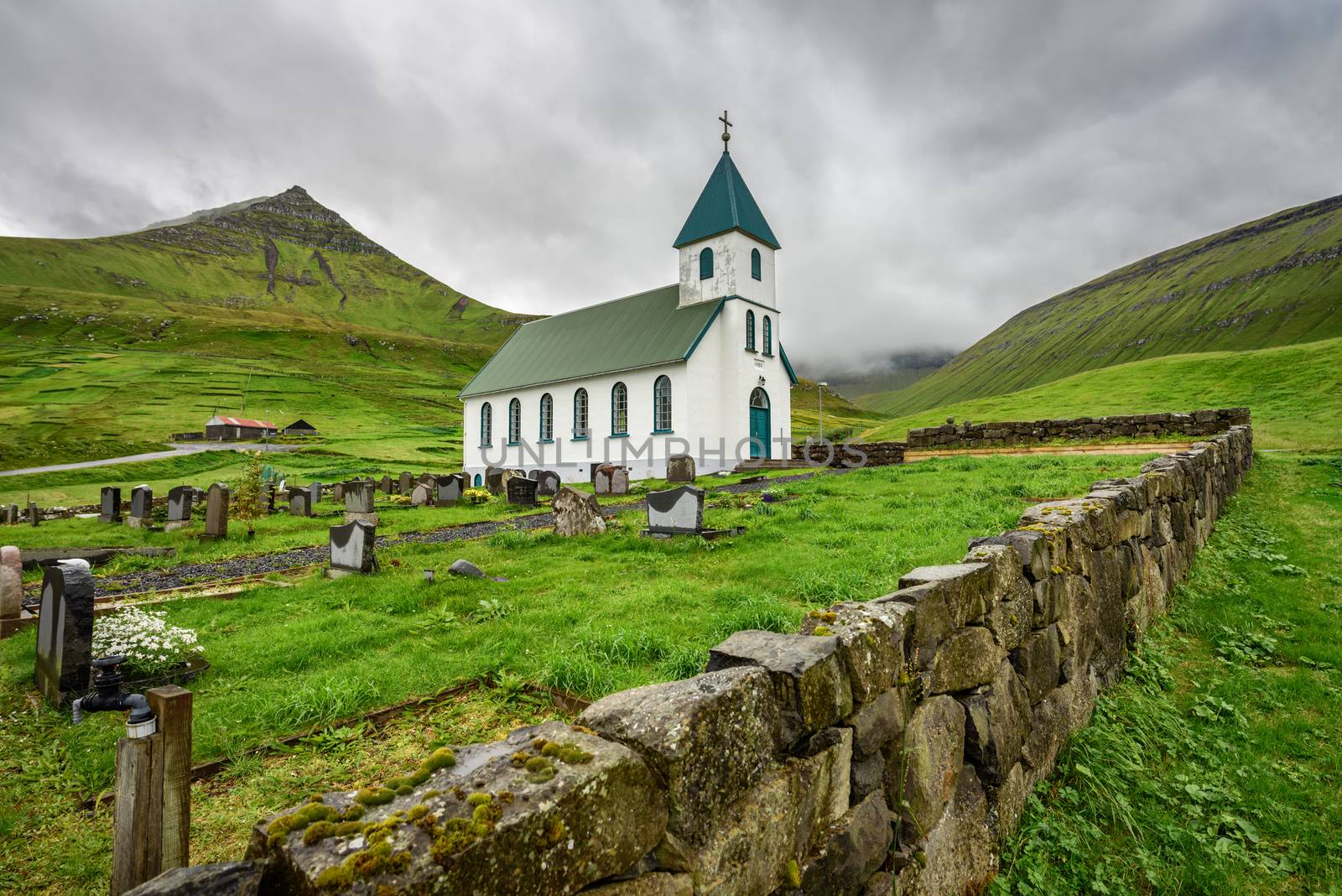 Small village church with cemetery in Gjogv located on the northeast tip of the island of Eysturoy, Faroe Islands, Denmark