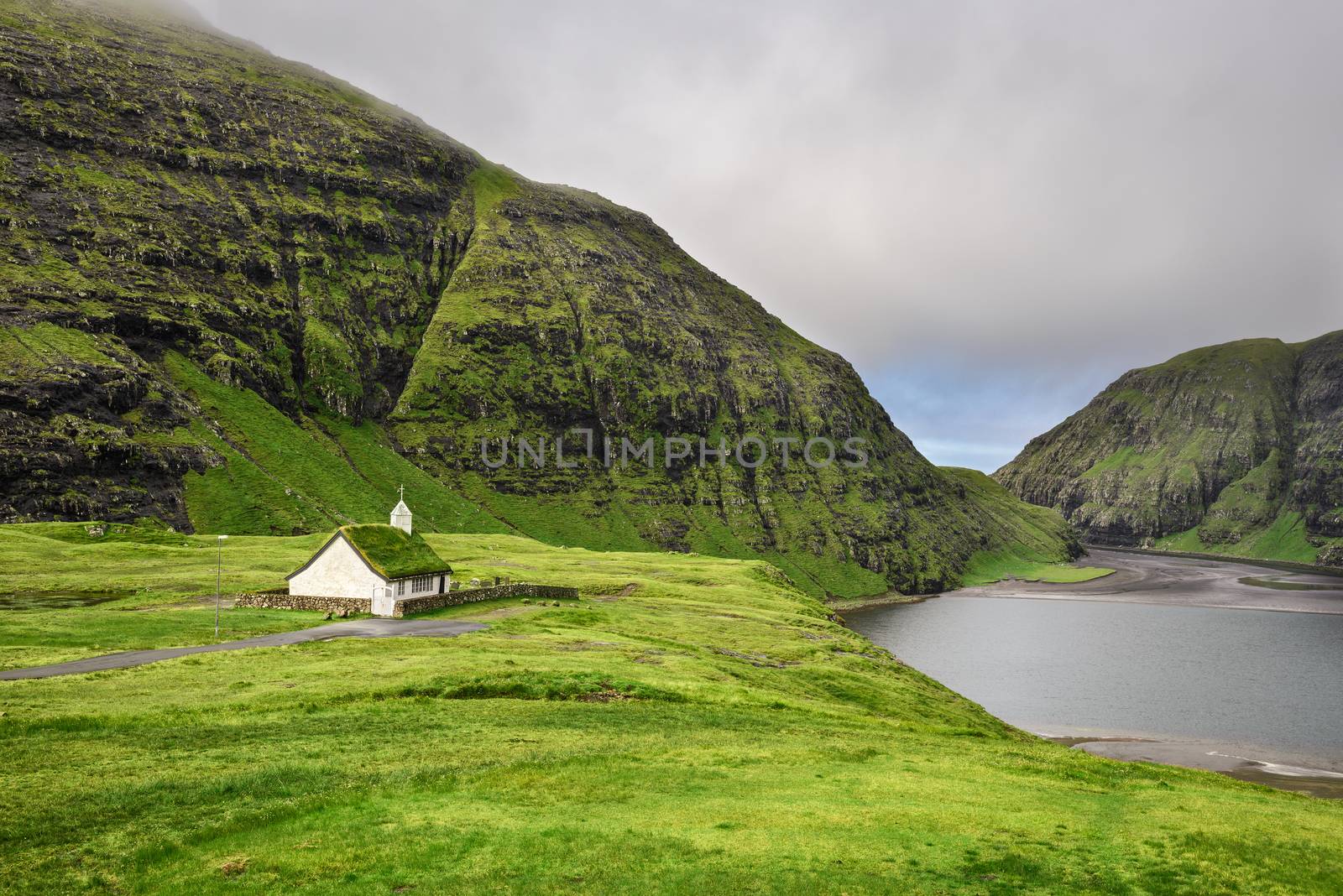Small village church in Saksun and a nearby lake located on the island of Streymoy, Faroe Islands, Denmark