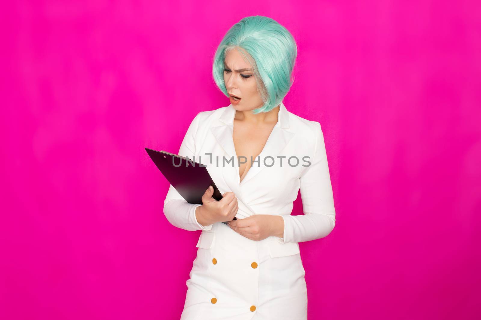 Beautiful young woman with short blue hair in a white business dress jacket holding a black folder with documents