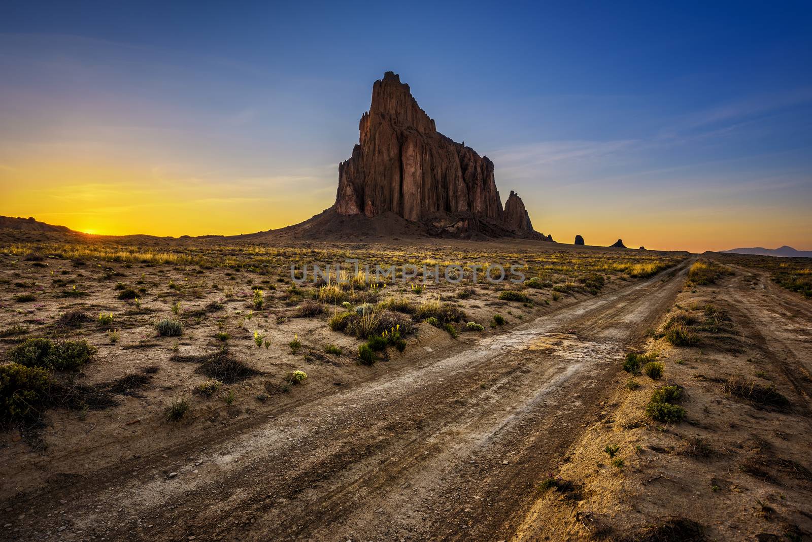 Sunset above Shiprock. Shiprock is a great volcanic rock mountain rising high above the high-desert plain of the Navajo Nation in New Mexico, USA