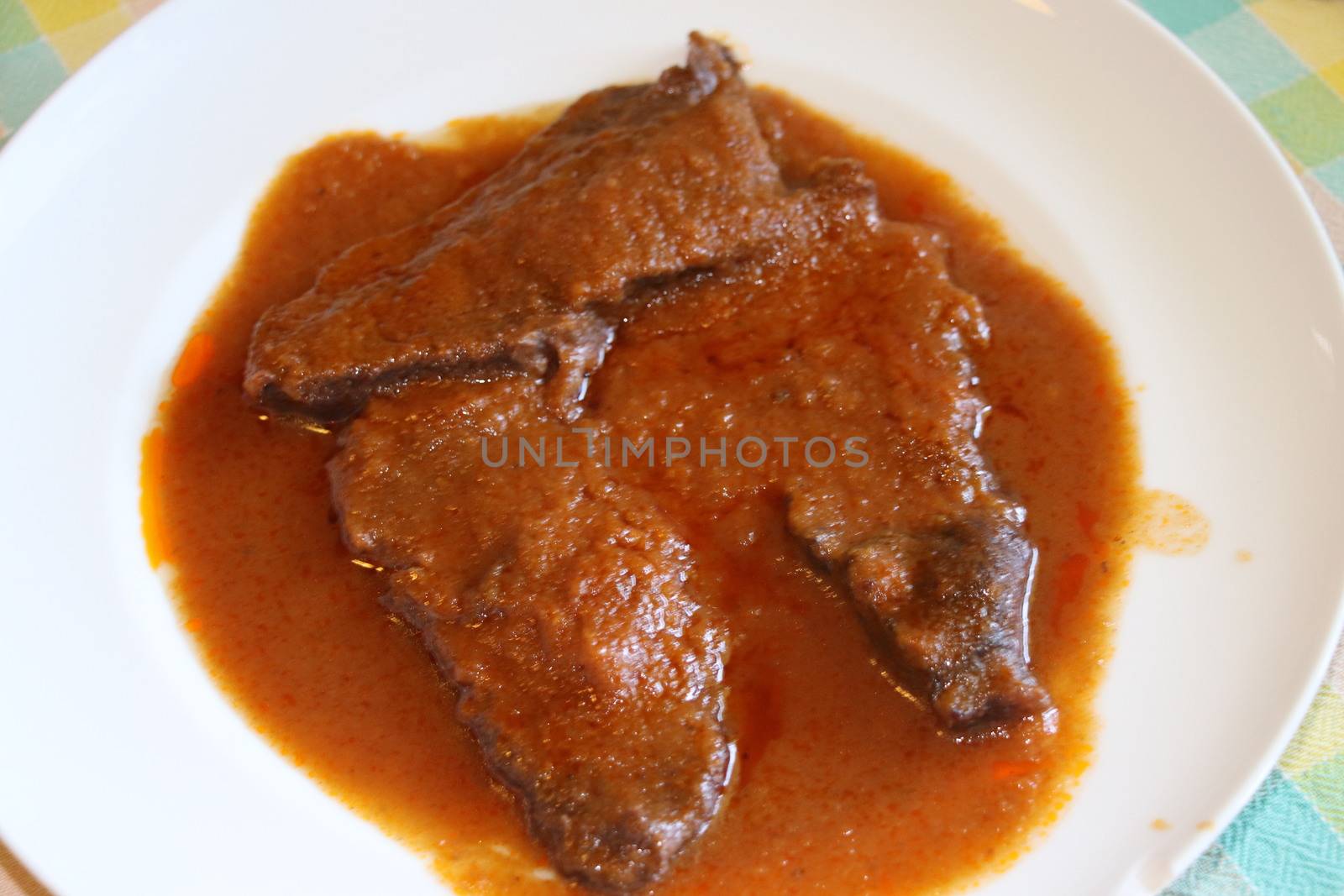 braised meat slices in the dish with sauce