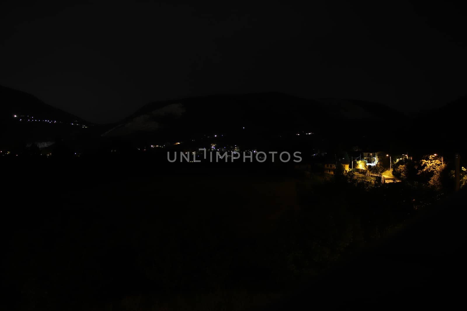 night landscape with street lights and mountains