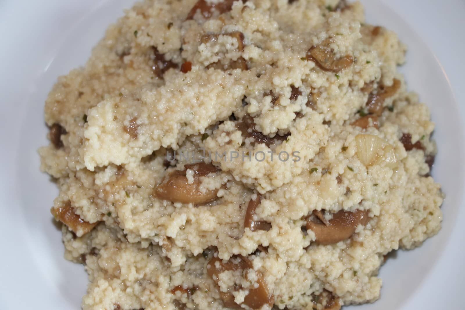 Dish with mushroom and couscous in a plate