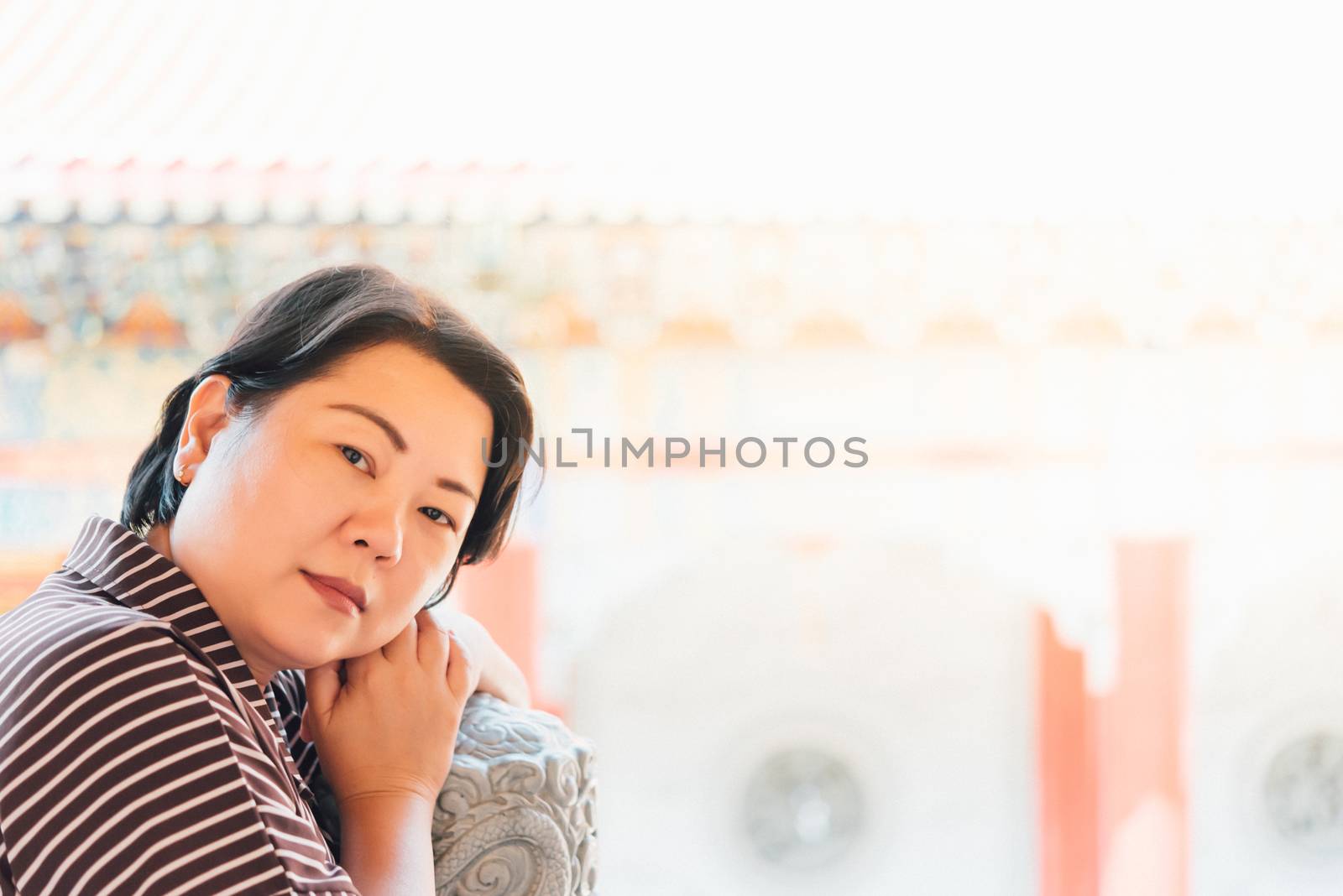 Asian woman 40s white skin plump body at Wat Boromracha Kanchanapisek Anusorn (Leng Noei Yi 2) is a Chinese temple under the patronage of the Chinese Buddhist Sangha in Thailand or Mahayana Buddhism.