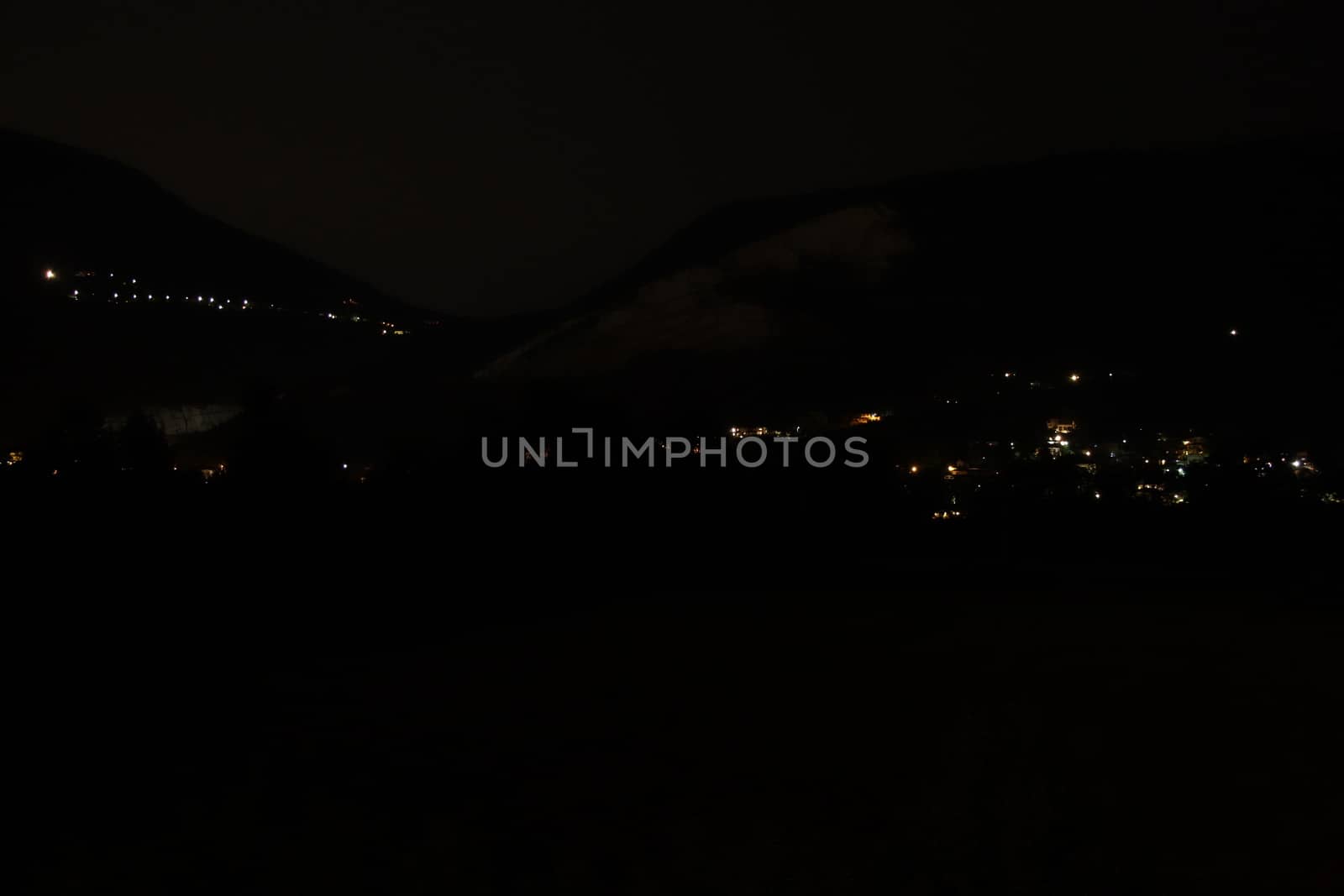 night landscape with street lights and mountains