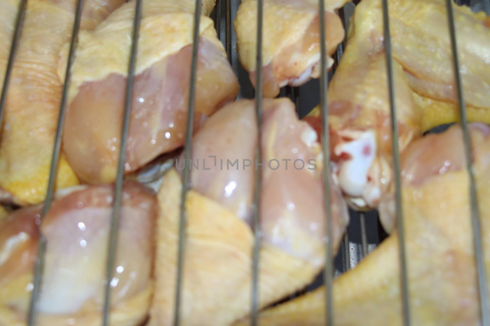 Processcooking chicken legs and chicken breast on a barbecue grill outdoors. Picnic, eating outdoors. Metal barbecue grill brazier .