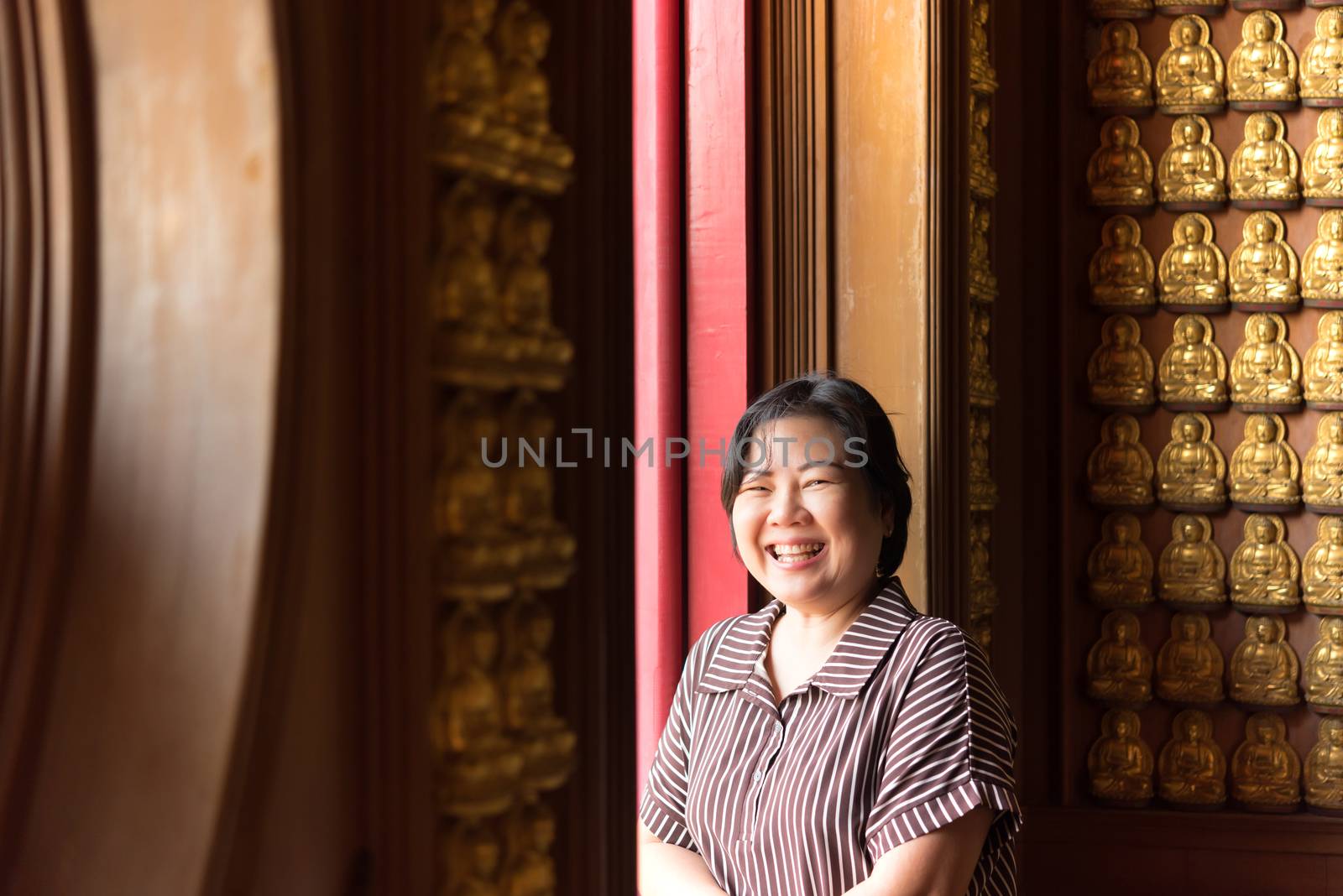 Asian woman 40s white skin plump body at Wat Boromracha Kanchanapisek Anusorn (Leng Noei Yi 2) is a Chinese temple under the patronage of the Chinese Buddhist Sangha in Thailand or Mahayana Buddhism.