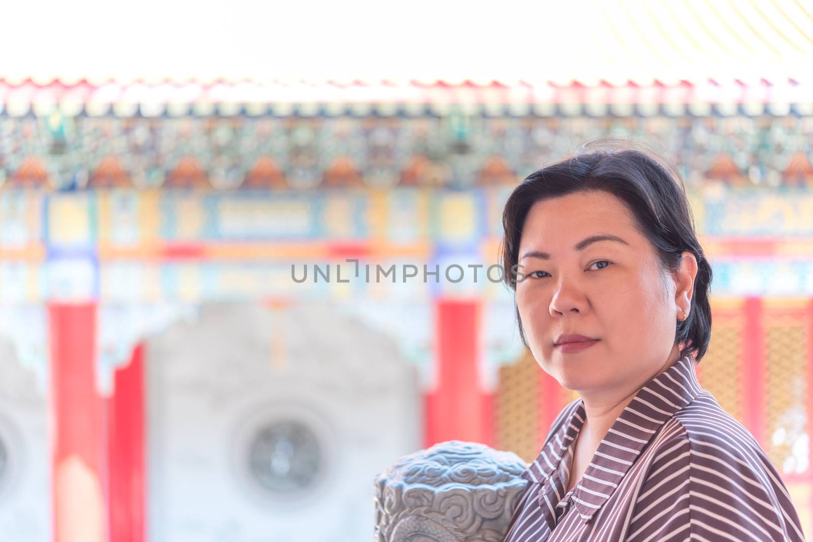 Asian woman 40s white skin plump body at Wat Boromracha Kanchanapisek Anusorn (Leng Noei Yi 2) is a Chinese temple under the patronage of the Chinese Buddhist Sangha in Thailand or Mahayana Buddhism.