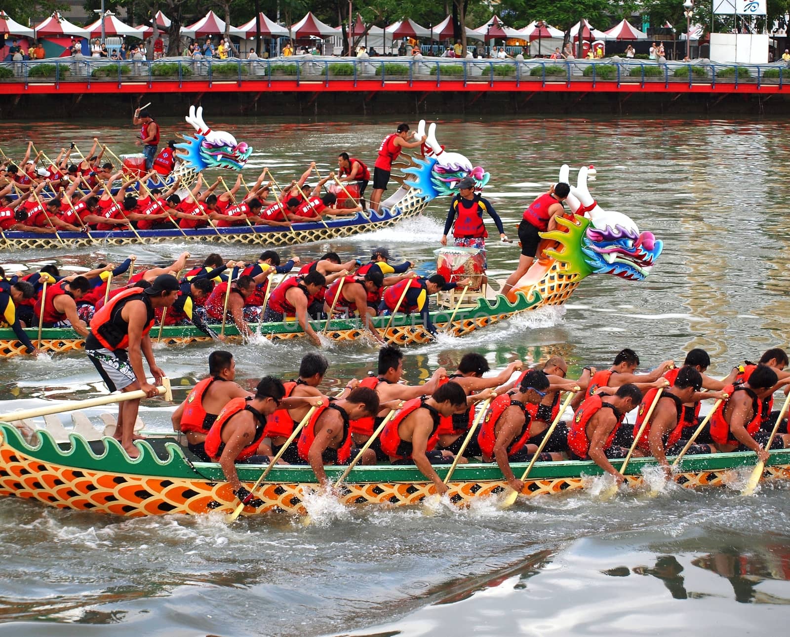 KAOHSIUNG, TAIWAN - JUNE 23: Four unidentified teams compete in the 2012 Dragon Boat Races on the Love River on June 23, 2012 in Kaohsiung
