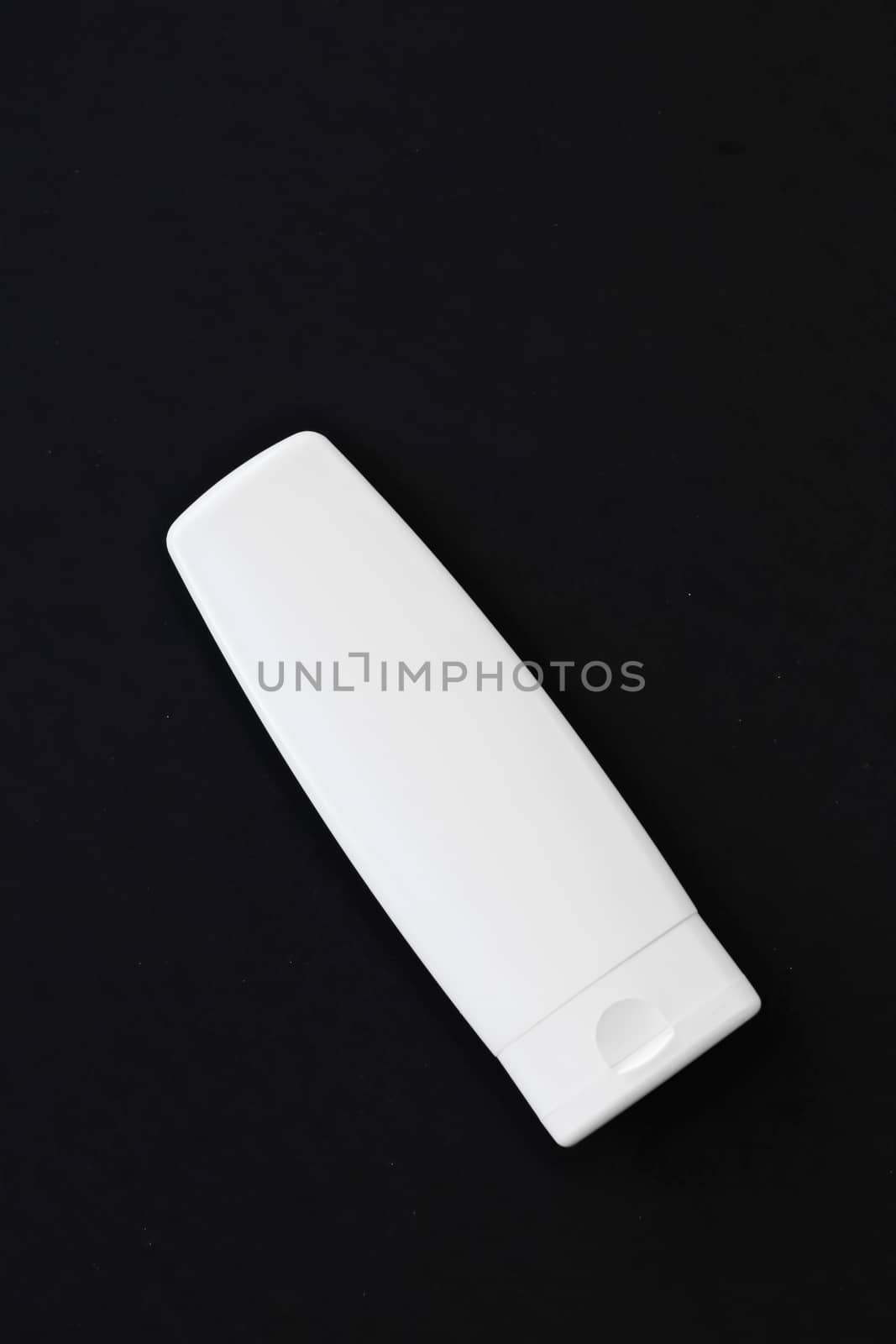 Blank label cosmetic container bottle as product mockup on black background by Anneleven