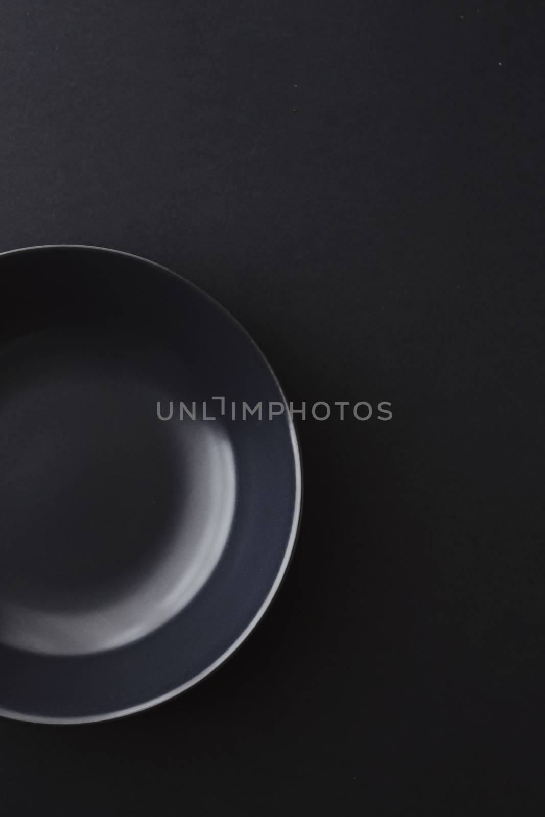 Empty plates on black background, premium dishware for holiday dinner, minimalistic design and diet concept