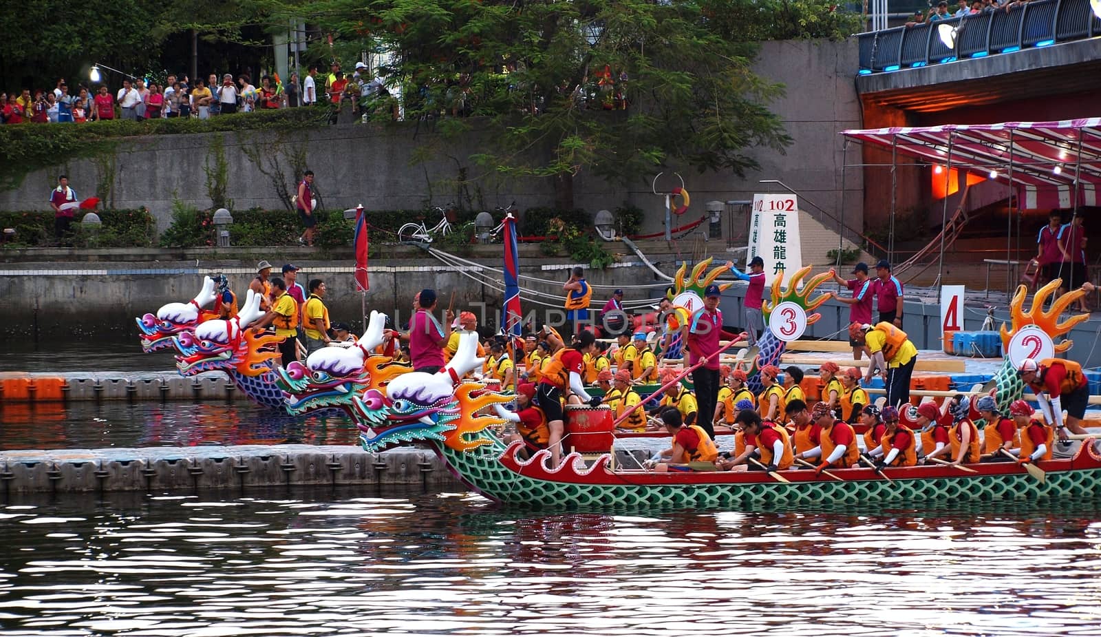 KAOHSIUNG, TAIWAN - JUNE 11: Four unidentified teams compete in the 2013 Dragon Boat Races on the Love River on June 11, 2013 in Kaohsiung