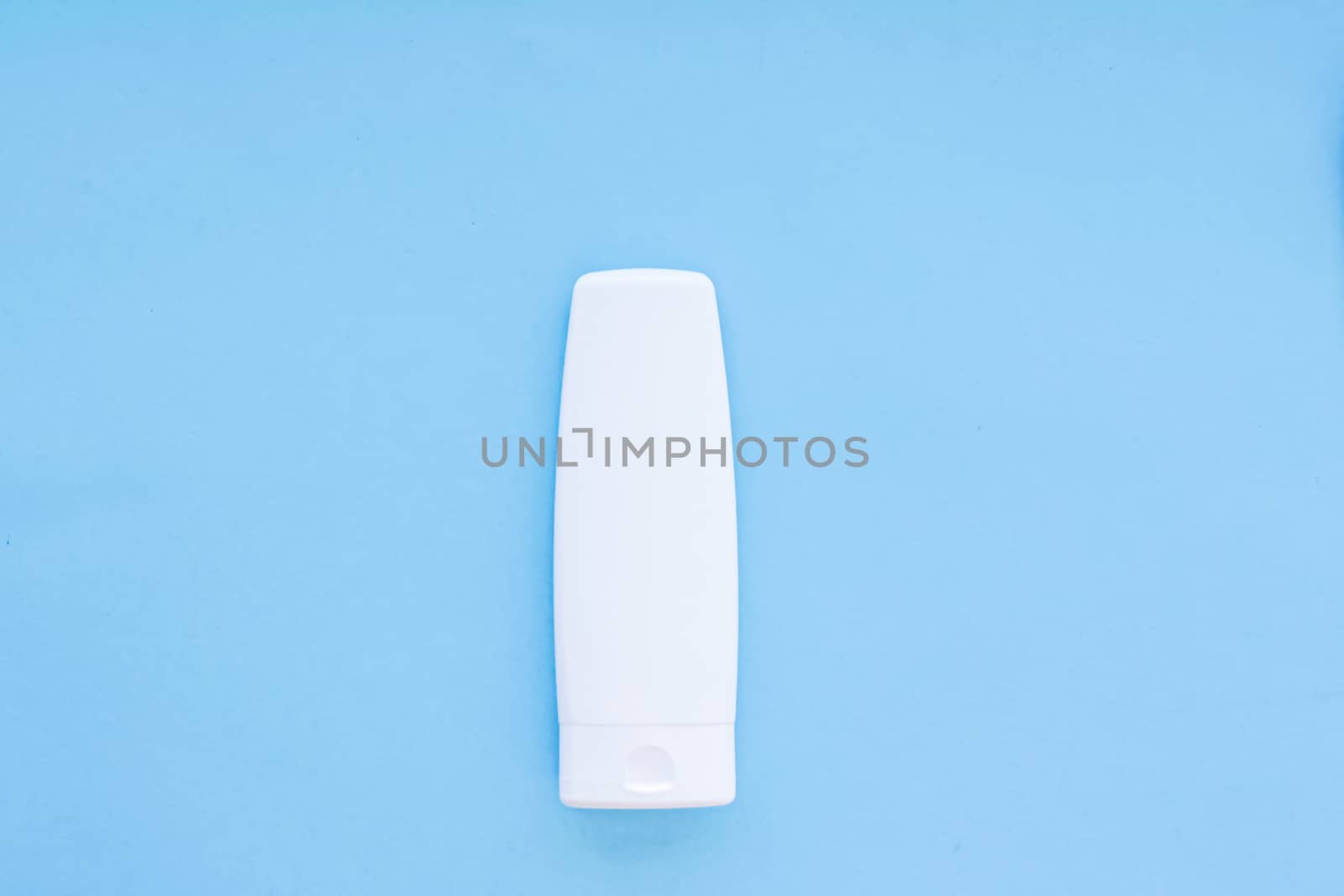 Blank label cosmetic container bottle as product mockup on blue background, hygiene and healthcare